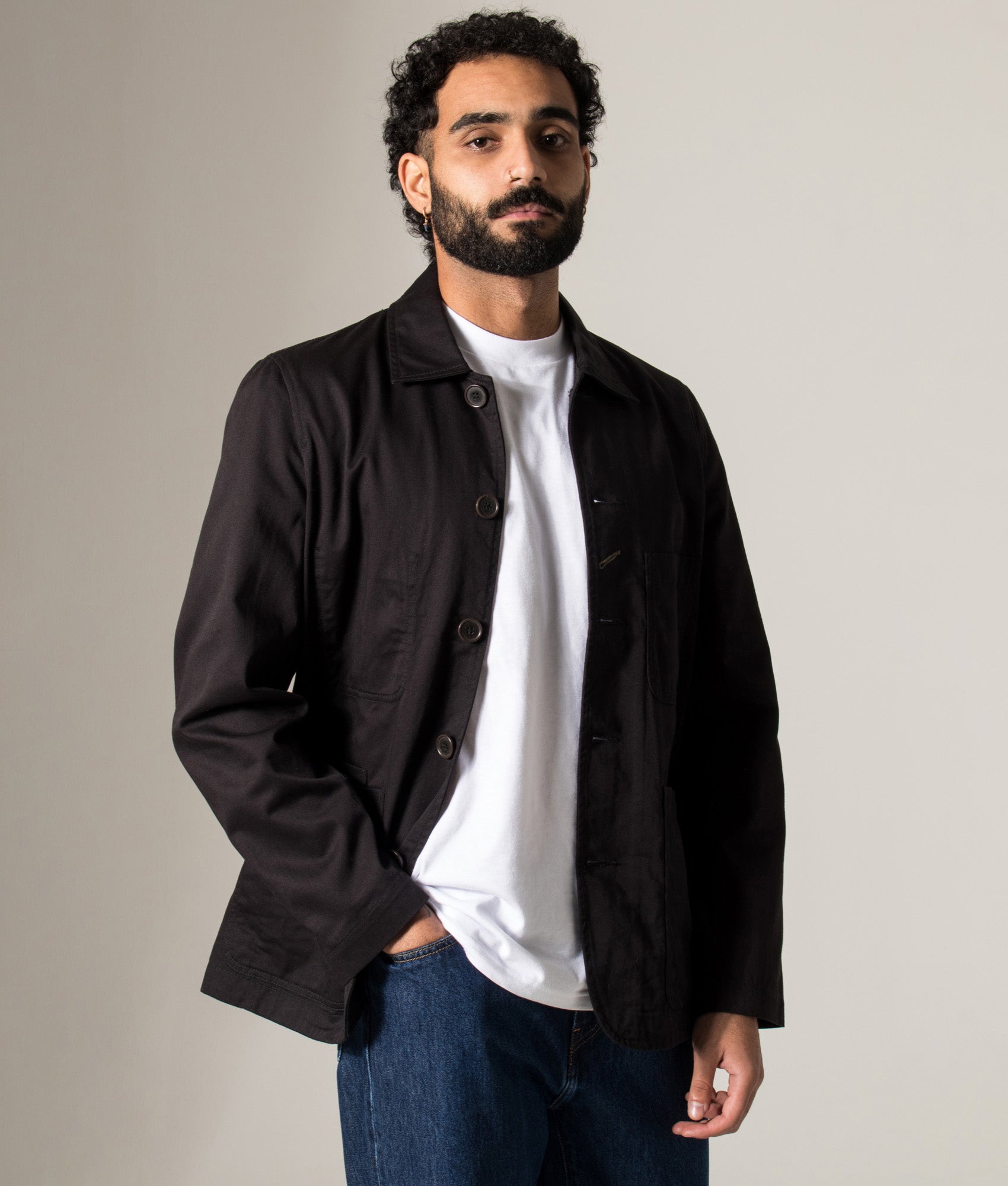 Universal Works Baker Jacket in Black at EQVVS Menswear. Model Front shot.