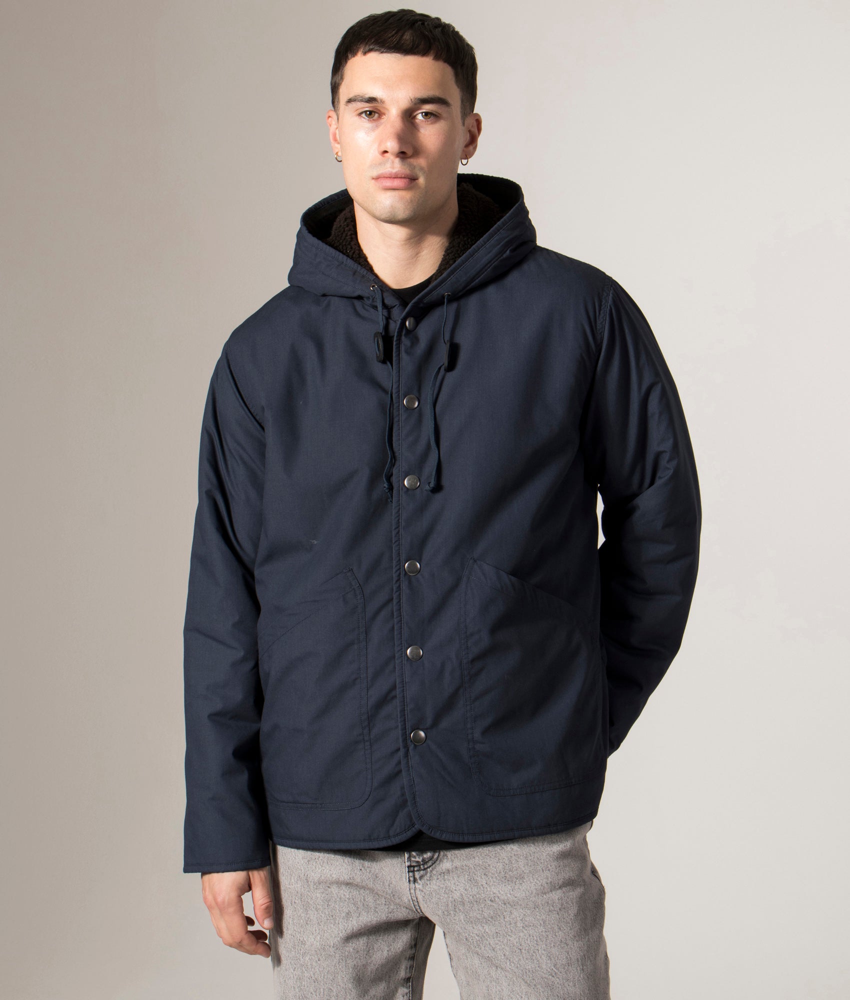 Universal Works Reversible Simple Hooded Jacket in Navy and brown fleece. Front Shot at EQVVS. Front model shot 