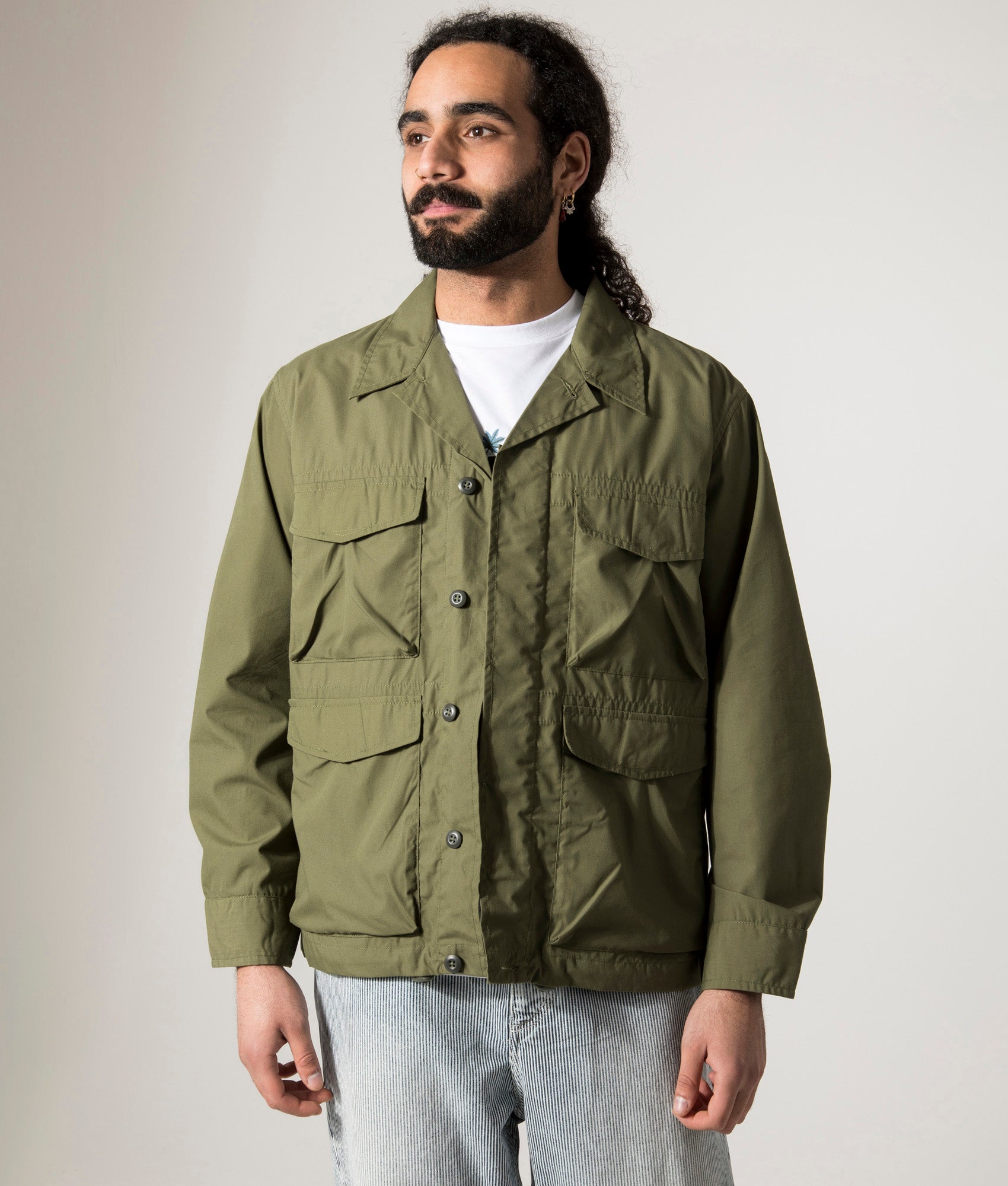 Universal Works Parachute Field Jacket in Olive. Shot at EQVVS.  Model Front shot. 