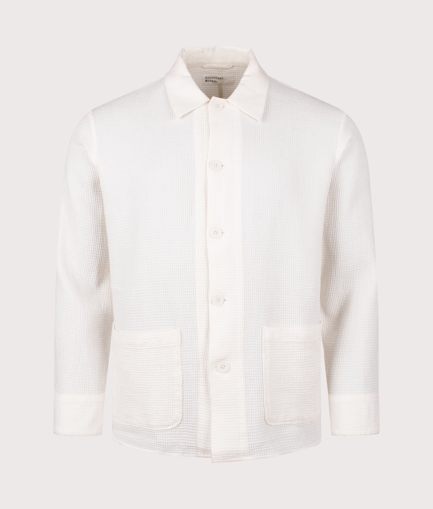 Universal Works Travail Overshirt in Ecru. Shot at EQVVS. Front shot. 