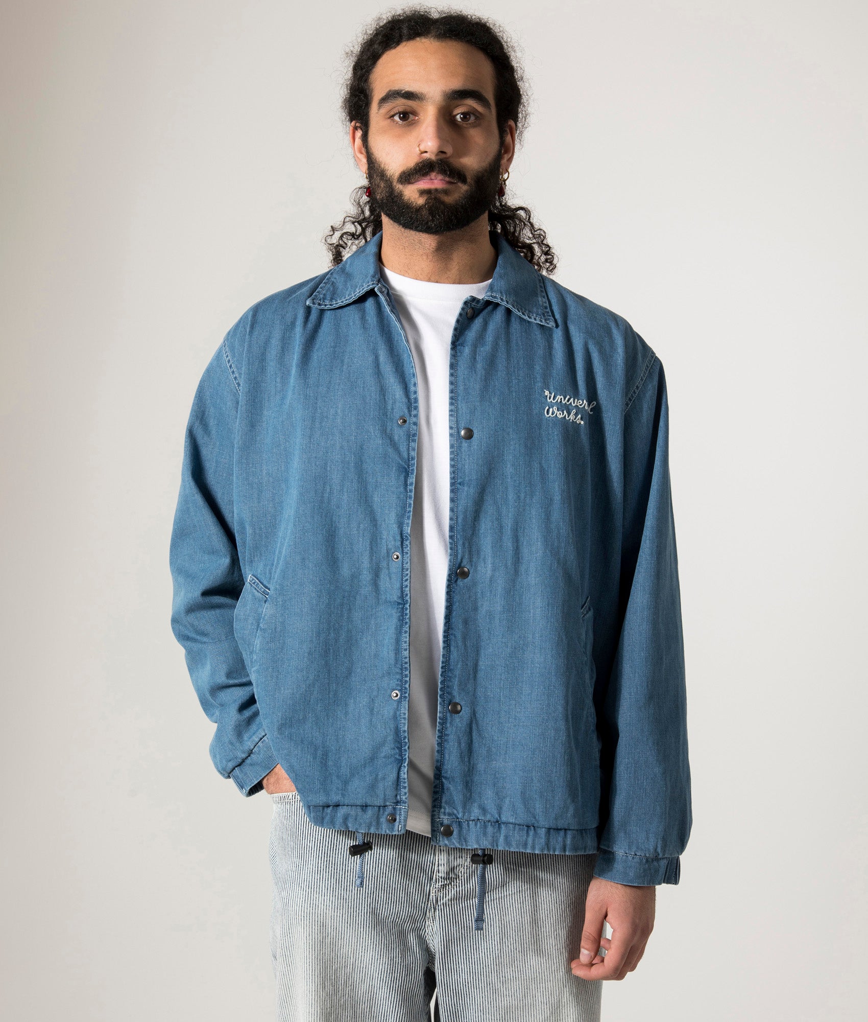 Universal Works Head Coach Jacket in Washed Indigo. Shot at EQVVS. Model Front shot. 