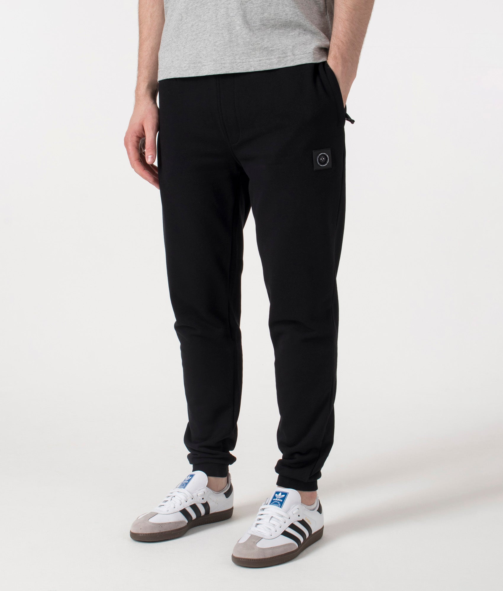 Marshall Artist Relaxed Fit Siren Joggers in Black at EQVVS. Front Angle  shot.