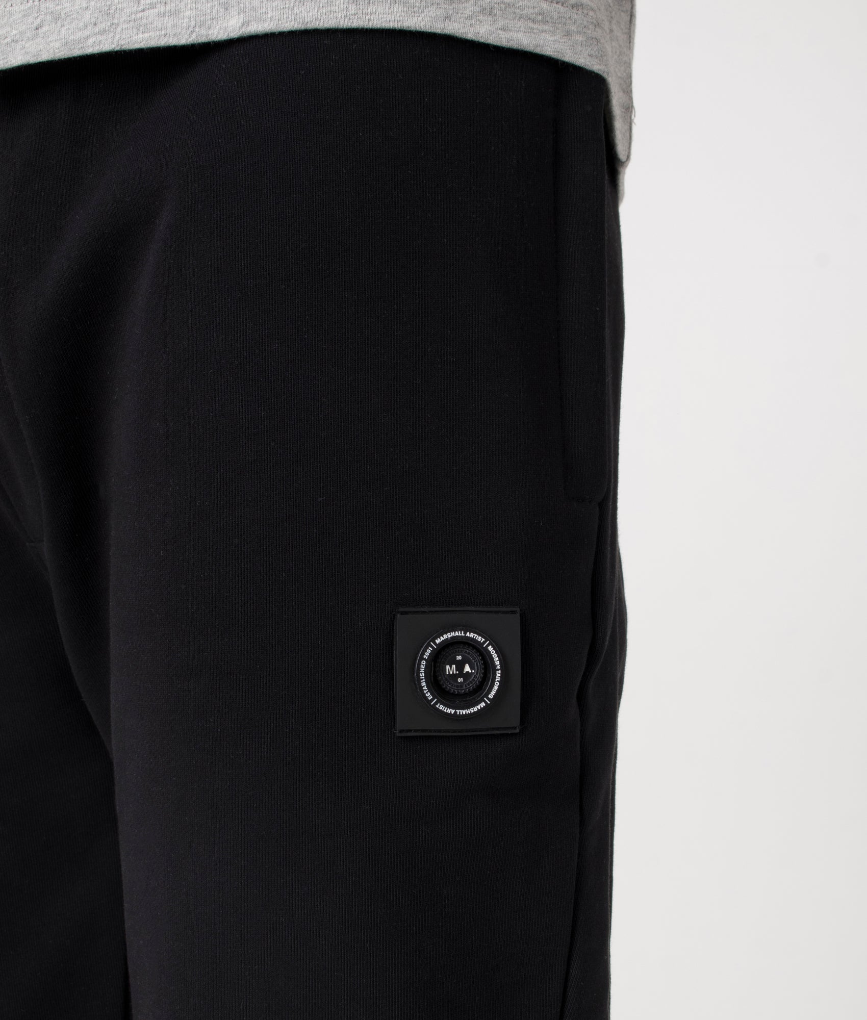 Marshall Artist Relaxed Fit Siren Joggers in Black at EQVVS. Detail shot.