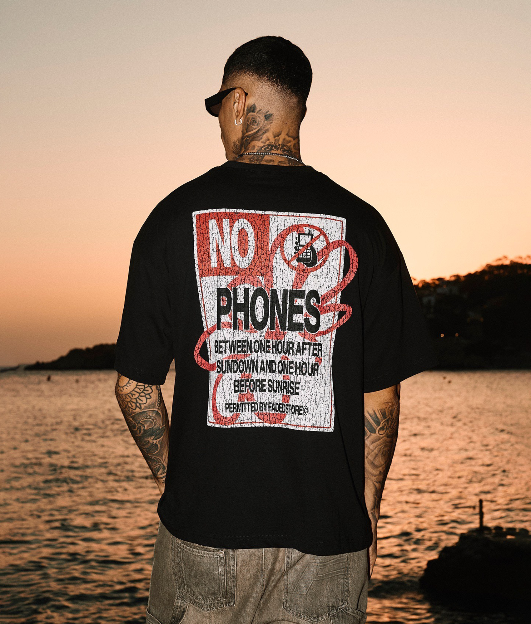 FADED No Phones T-shirt in black at EQVVS Menswear. Model campaign shot.
