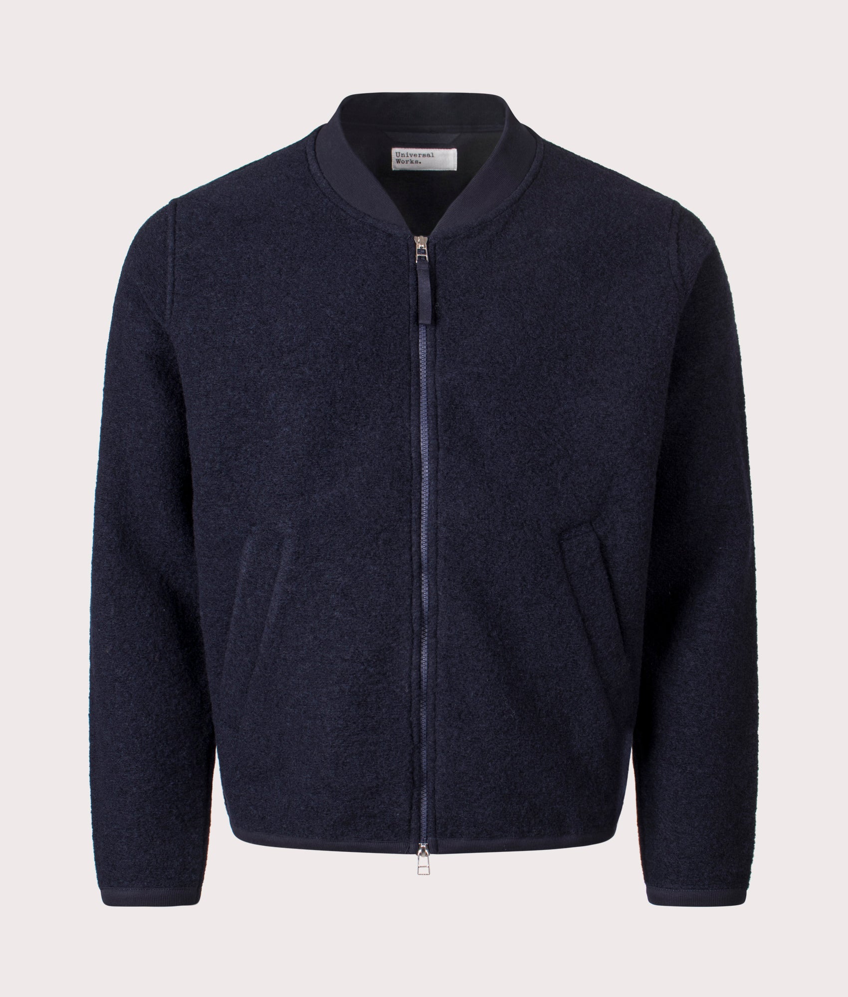 Universal Works Wool Zip Bomber Jacket in Navy at EQVVS Menswear. Front shot.