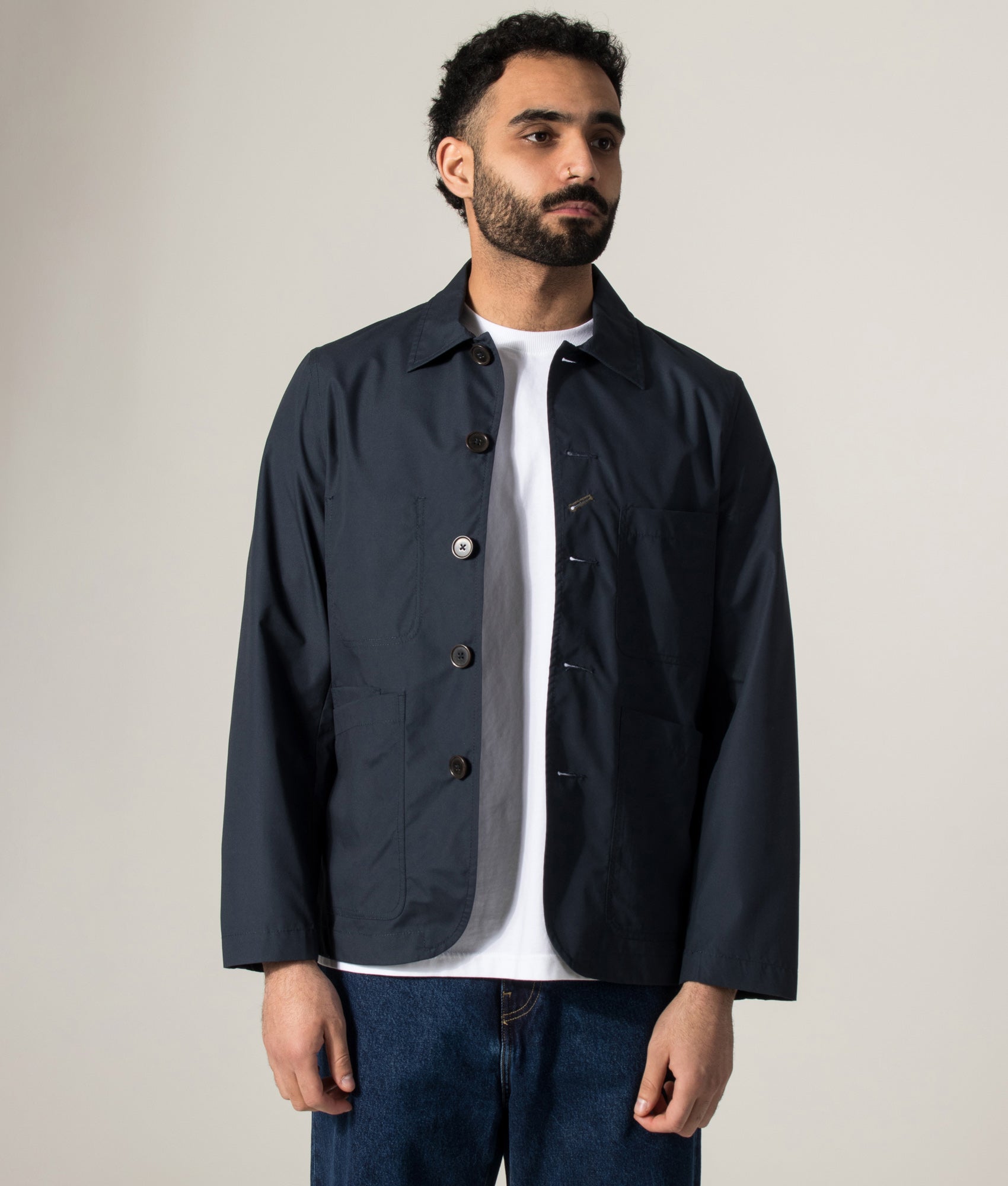 Universal Works Recycled Polytech Bakers Jacket in Navy at EQVVS Menswear. Model front shot.