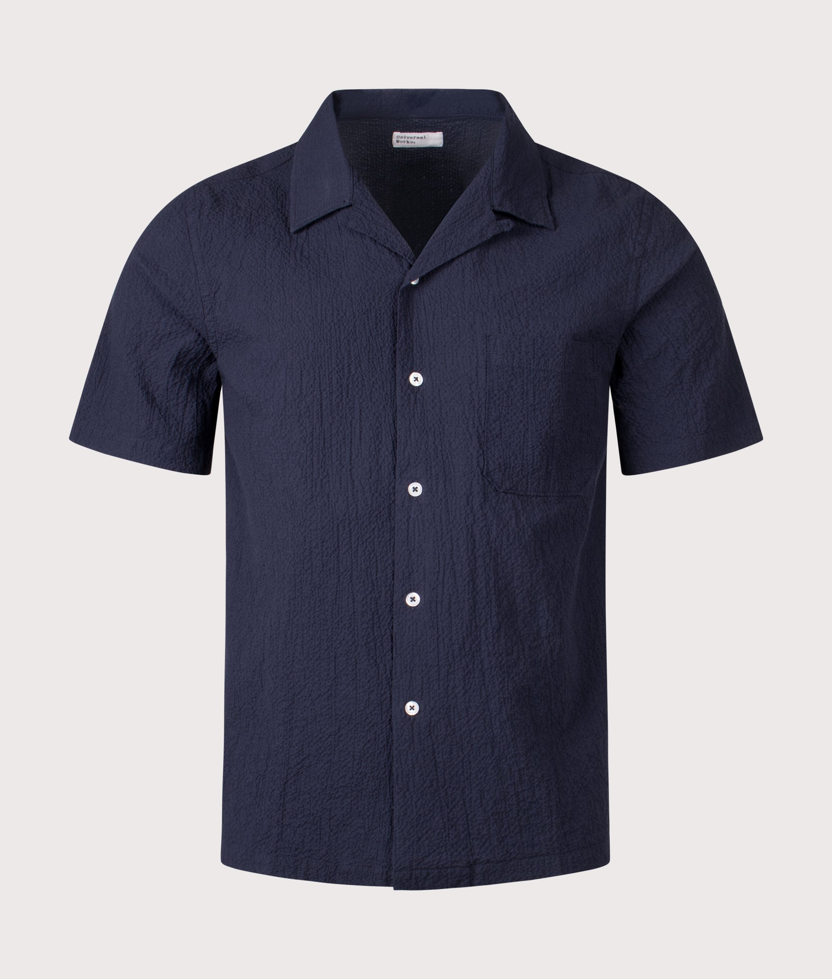 Universal Works Seersucker Road Shirt in Navy at EQVVS Menswear. Front shot.