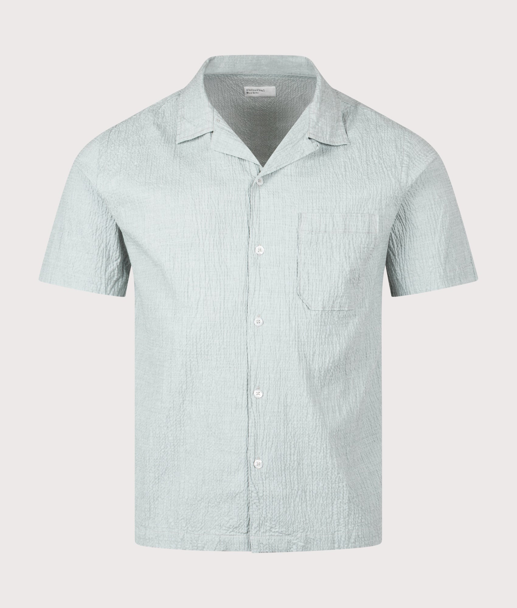 Universal Works Short Sleeve Seersucker Road Shirt in Green at EQVVS Menswear. Front shot.