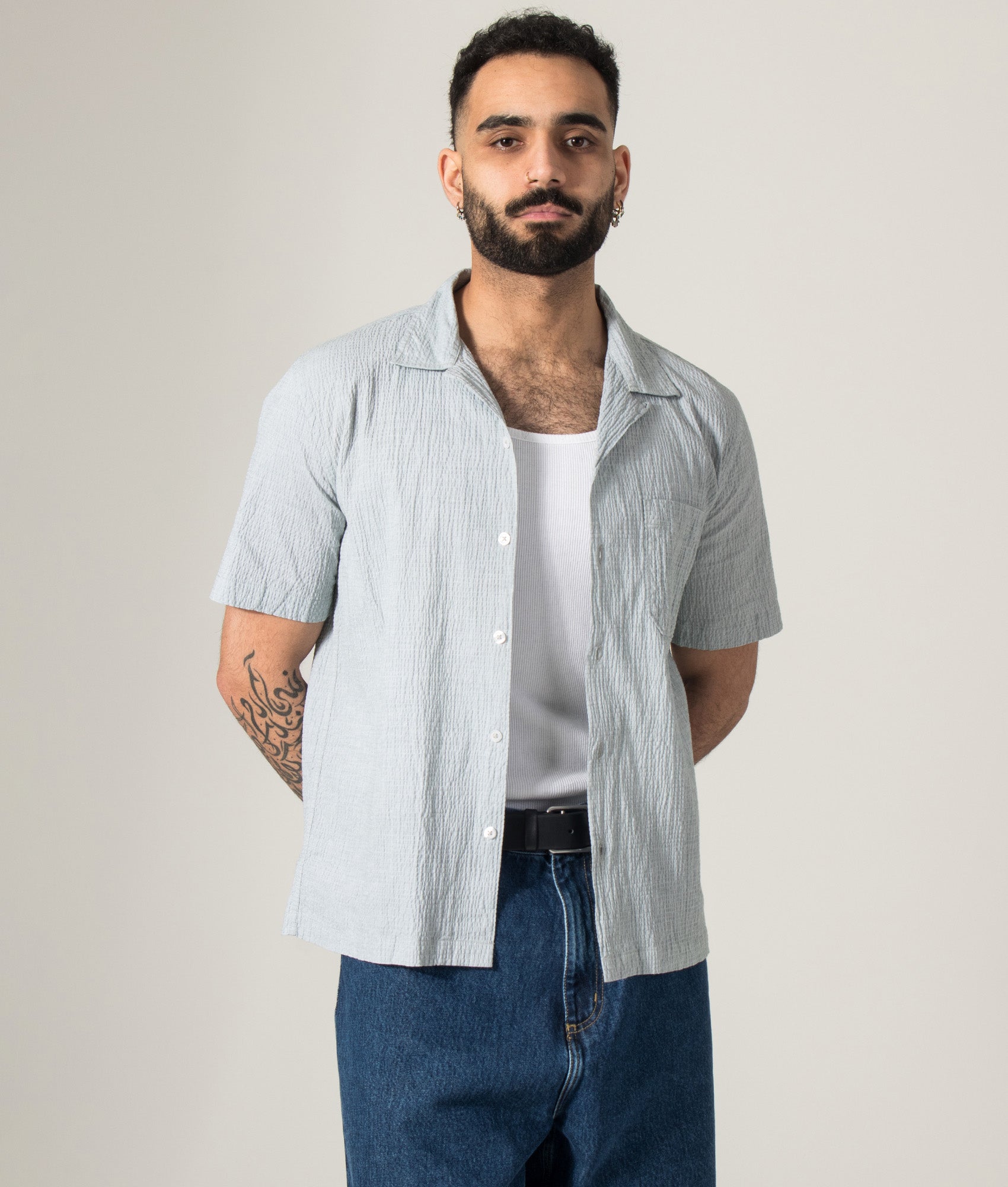 Universal Works Short Sleeve Seersucker Road Shirt in Green at EQVVS Menswear. Model front shot.