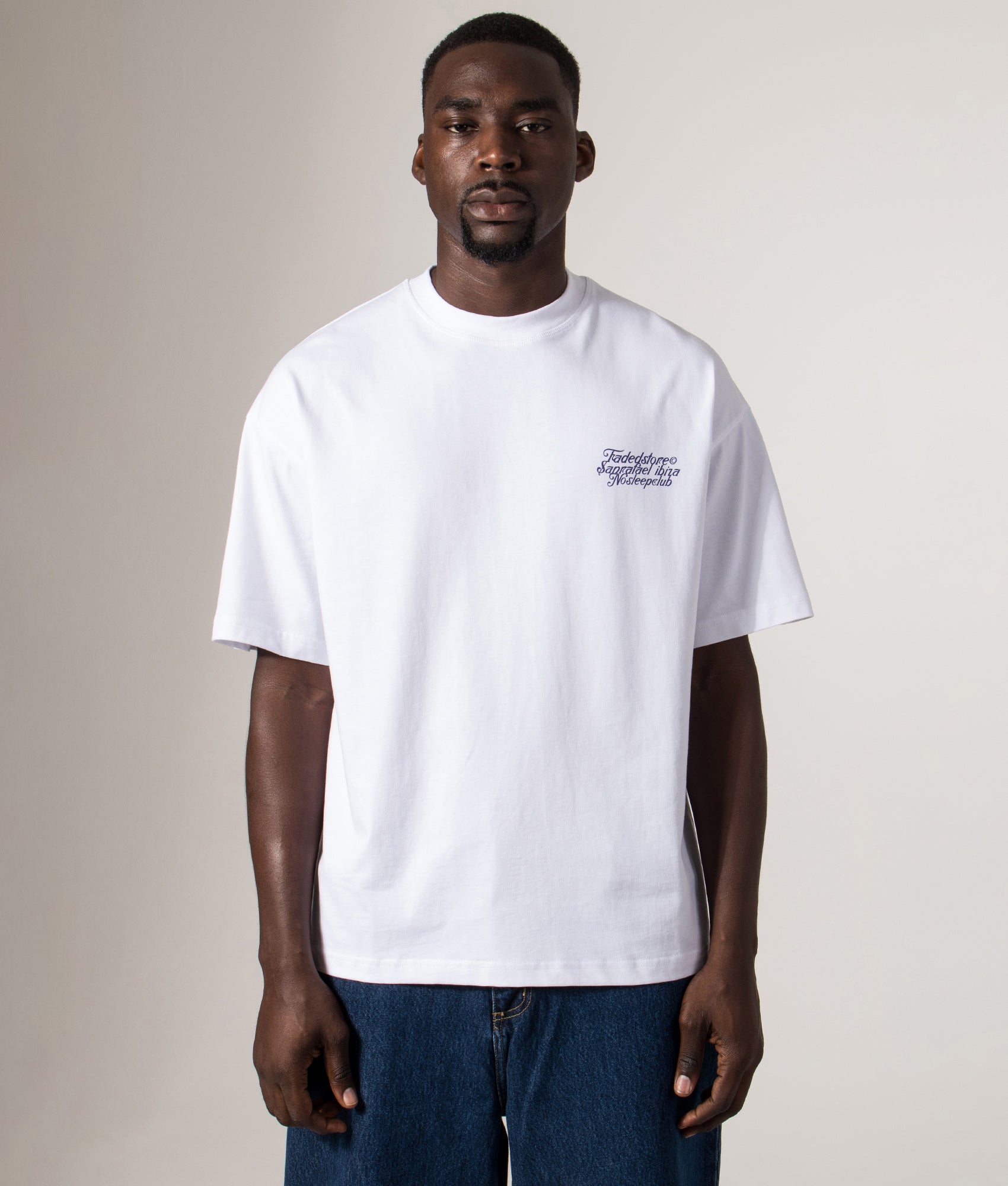 Faded Relaxed Fit NSC Face T-Shirt in White at EQVVS Menswear. Model front shot.
