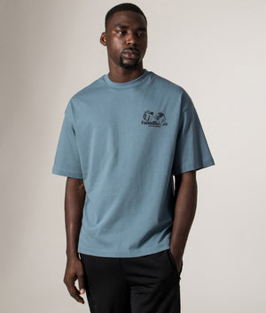 FADEDSTORE Relaxed Fit Take The Gamble T-Shirt in Dusky Blue at EQVVS Menswear. Model front shot.