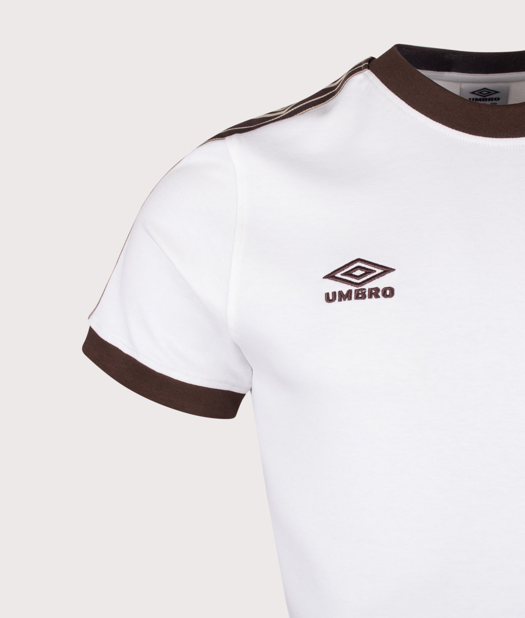 Umbro Taped T-Shirt in Brilliant White and Demitasse at EQVVS Menswear. Detail shot.