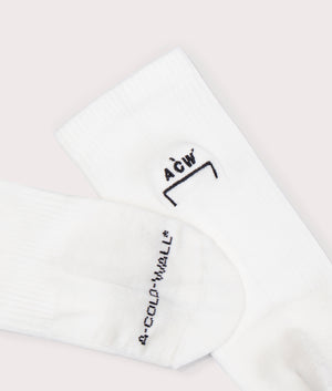 A-COLD-WALL* Bracket Socks in White with Black Ankle and Toe Branding Detail Shot at EQVVS 