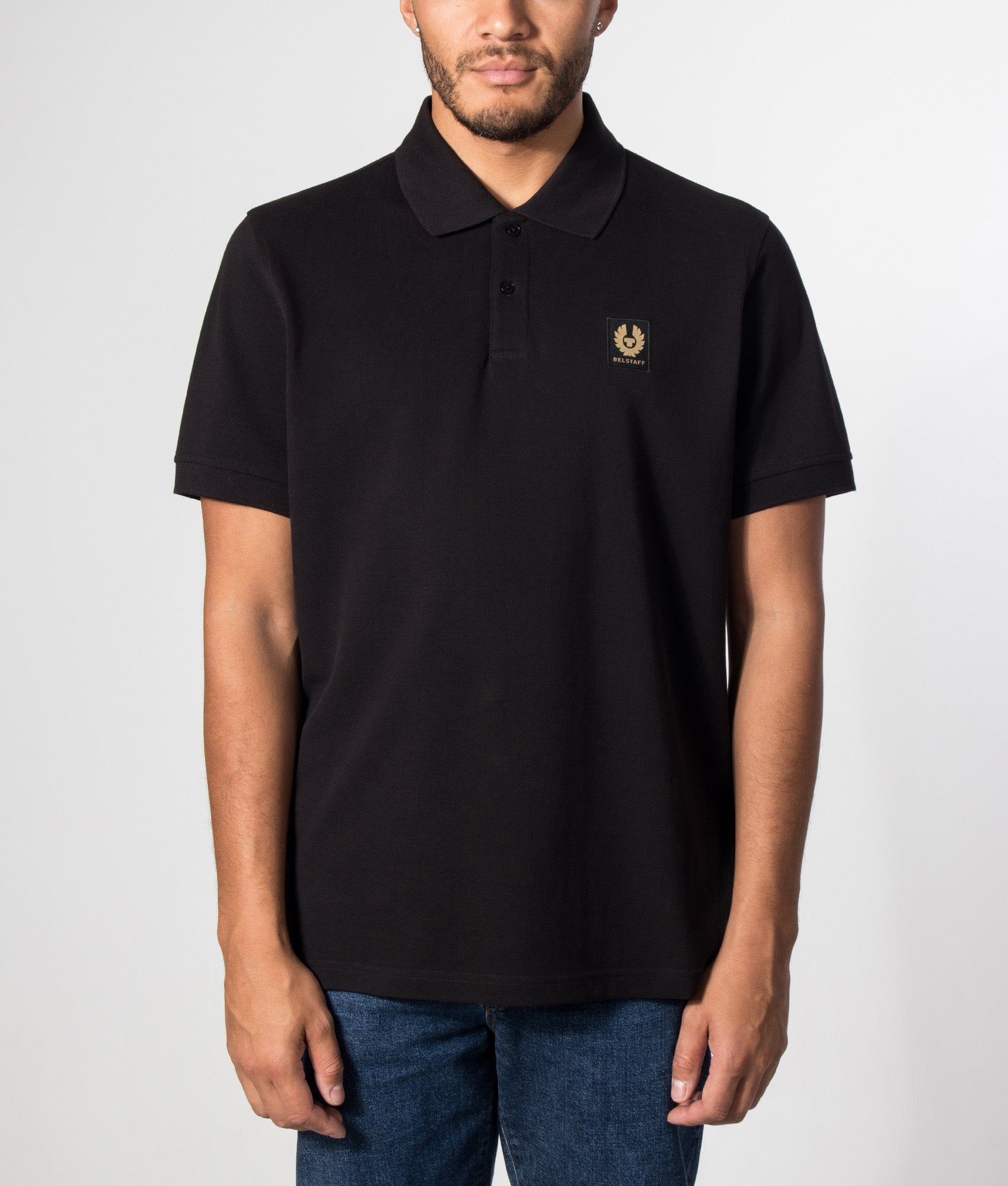 Belstaff Regular Fit Belstaff Polo Shirt in Black at EQVVS Menswear. Model front shot.