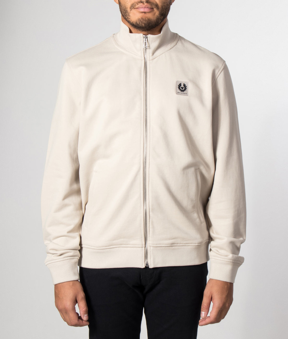 Belstaff Regular Fit Belstaff Full Zip Sweatshirt in Pale Stone at EQVVS Menswear. Model front shot.