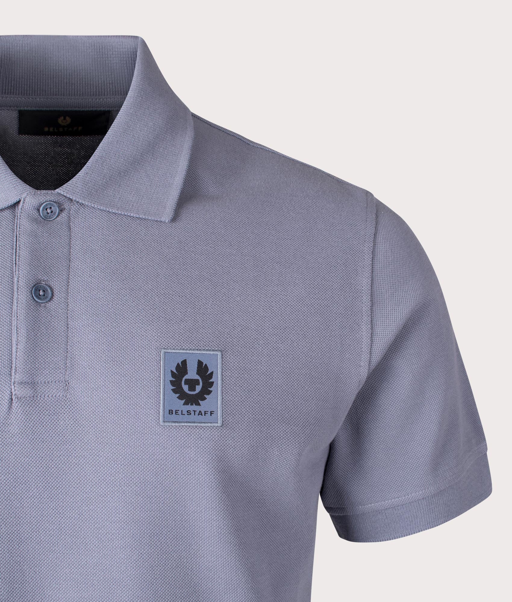 Belstaff Polo Shirt in Blue Flint, 100% Cotton. At EQVSS Menswear. Front logo shot. 