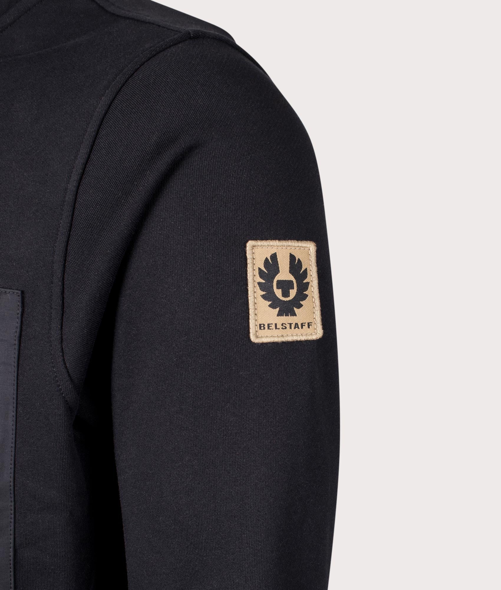 Belstaff Centenary Full Zip Sweatshirt in Black, 100% cotton at EQVVS. Detailed badge shot. 