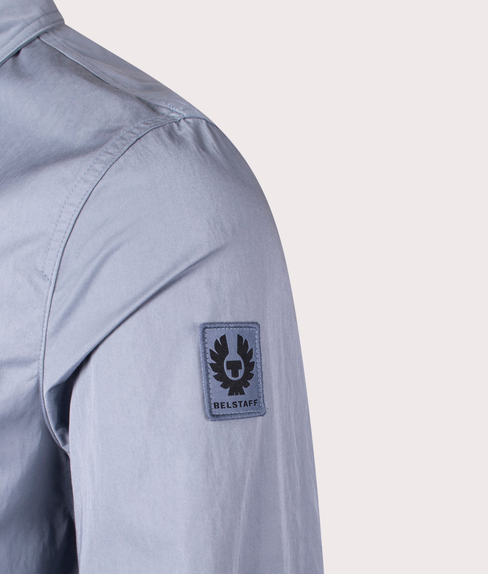 Belstaff Drome Overshirt in Blue Flint, Cotton/Nylon blend. At EQVVS Menswear. Front angle logo shot