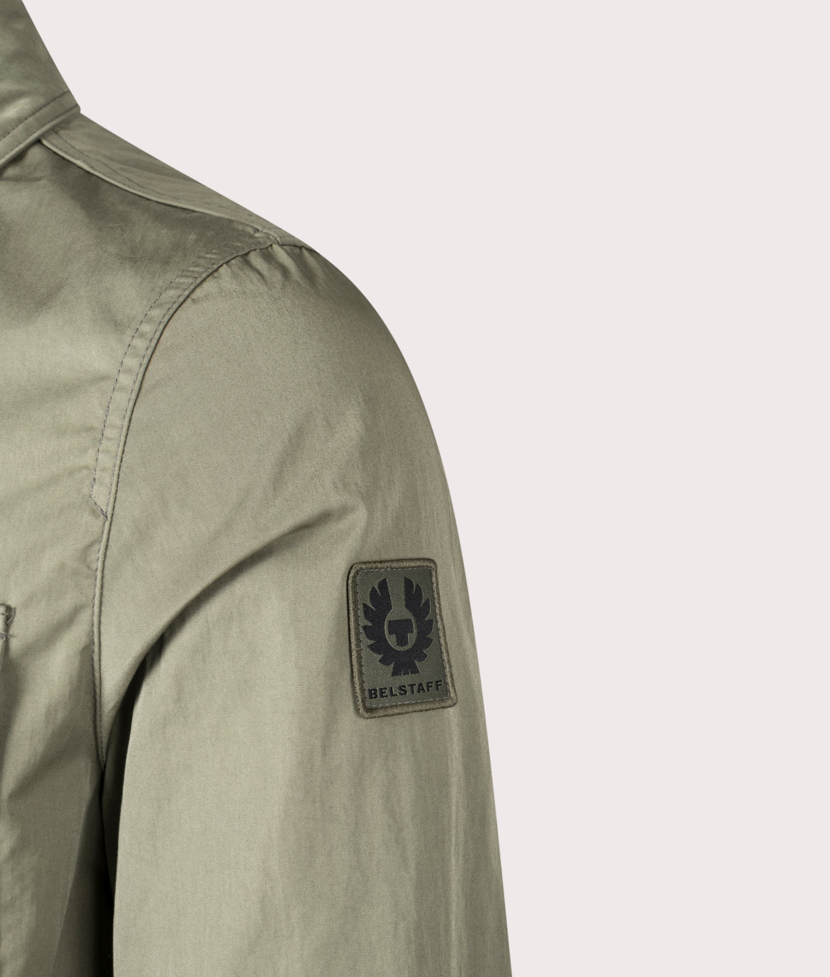 Belstaff Drome Overshirt in Surplus Green, Cotton/Nylon blend. At EQVVS Menswear. Front angle logo shot