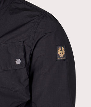 Belstaff Service Racemaster Jacket in Black at EQVVS. Detailed logo shot. 