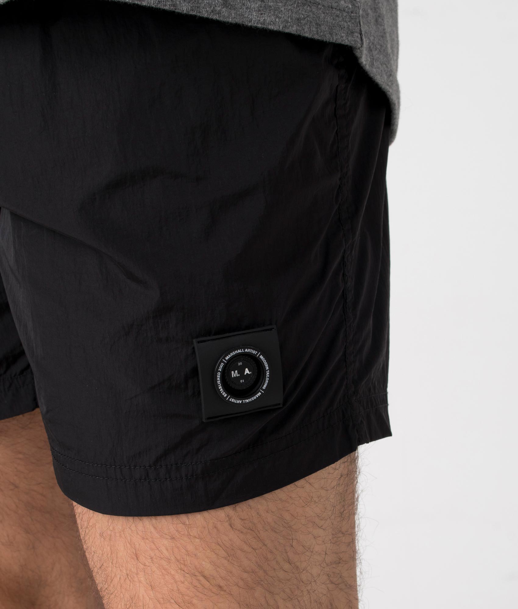 Marshall Artist Krinkle Nylon Siren Swim Shorts in Black. Detail shot at EQVVS.
