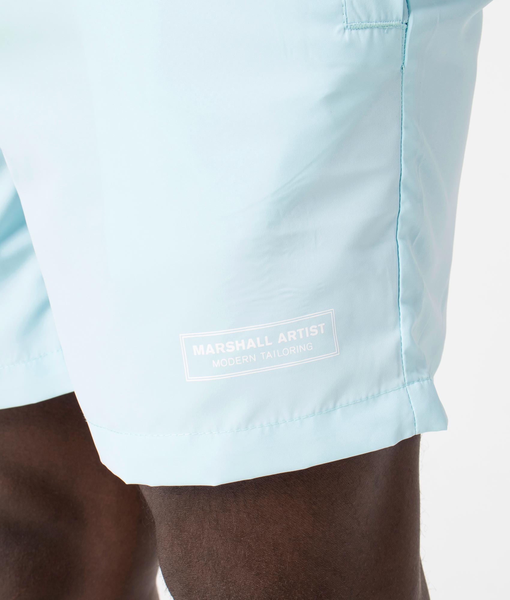 Signature Swim Shorts in Sky Blue by Marshall Artist. EQVVS Detail Shot.