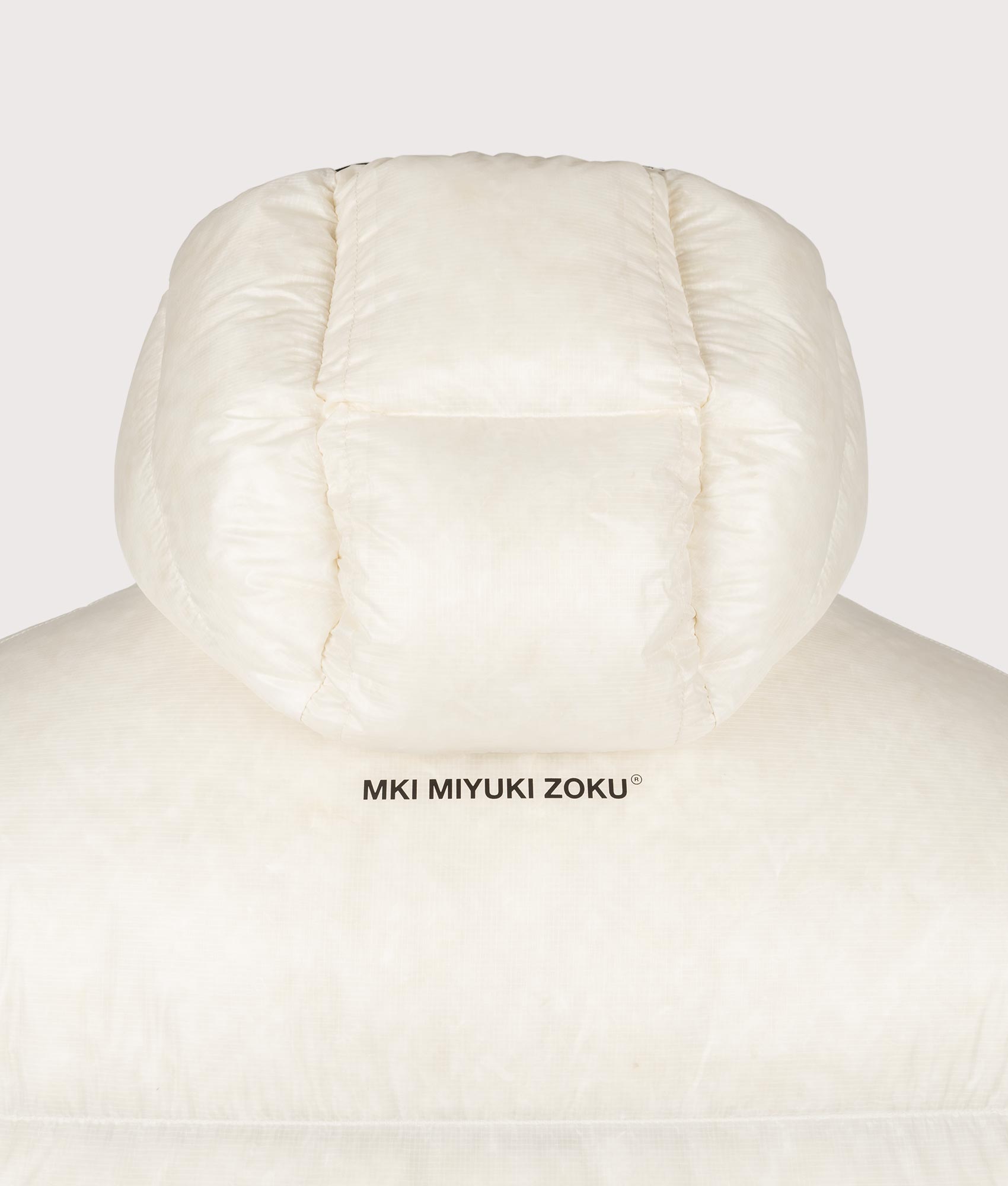 MKI MIYUKI ZOKU Translucent Bubble Jacket in Off White at EQVVS Menswear. Back detail shot.