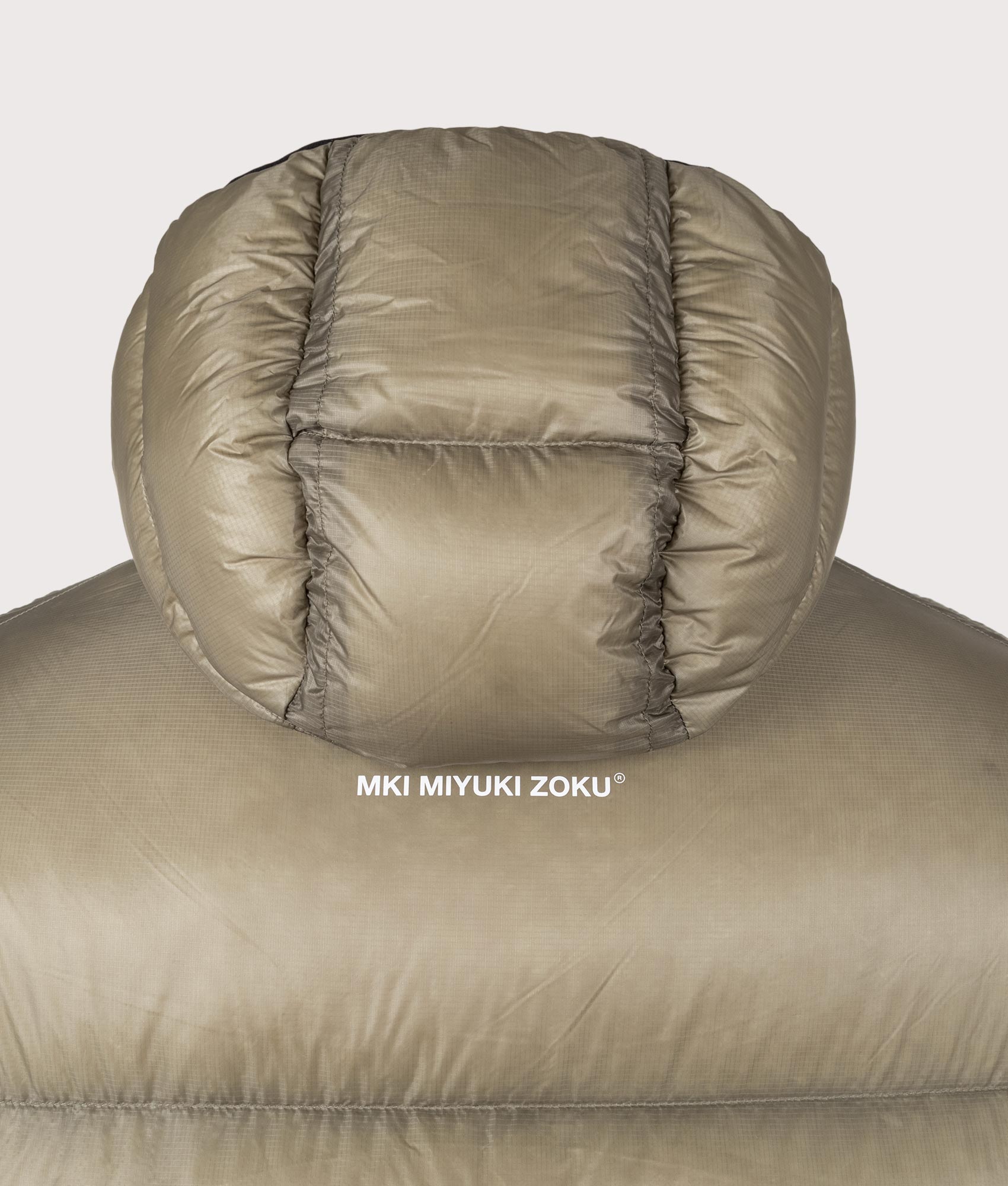 MKI MIYUKI ZOKU Translucent Bubble Jacket in Sage at EQVVS Menswear. Detail shot.