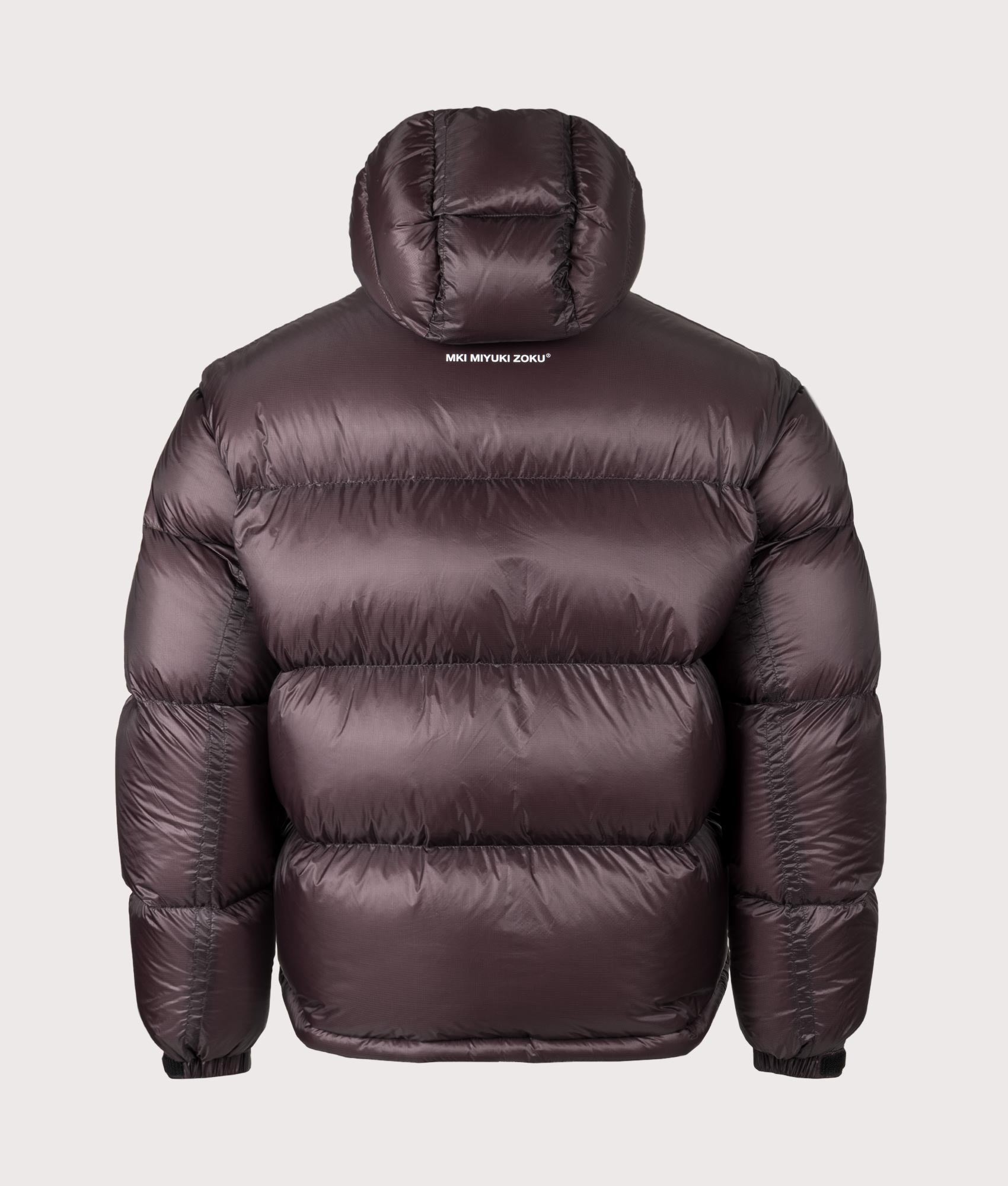 MKI MIYUKI ZOKU Translucent Hooded Bubble Jacket in Raisin at EQVVS Menswear. Back shot.