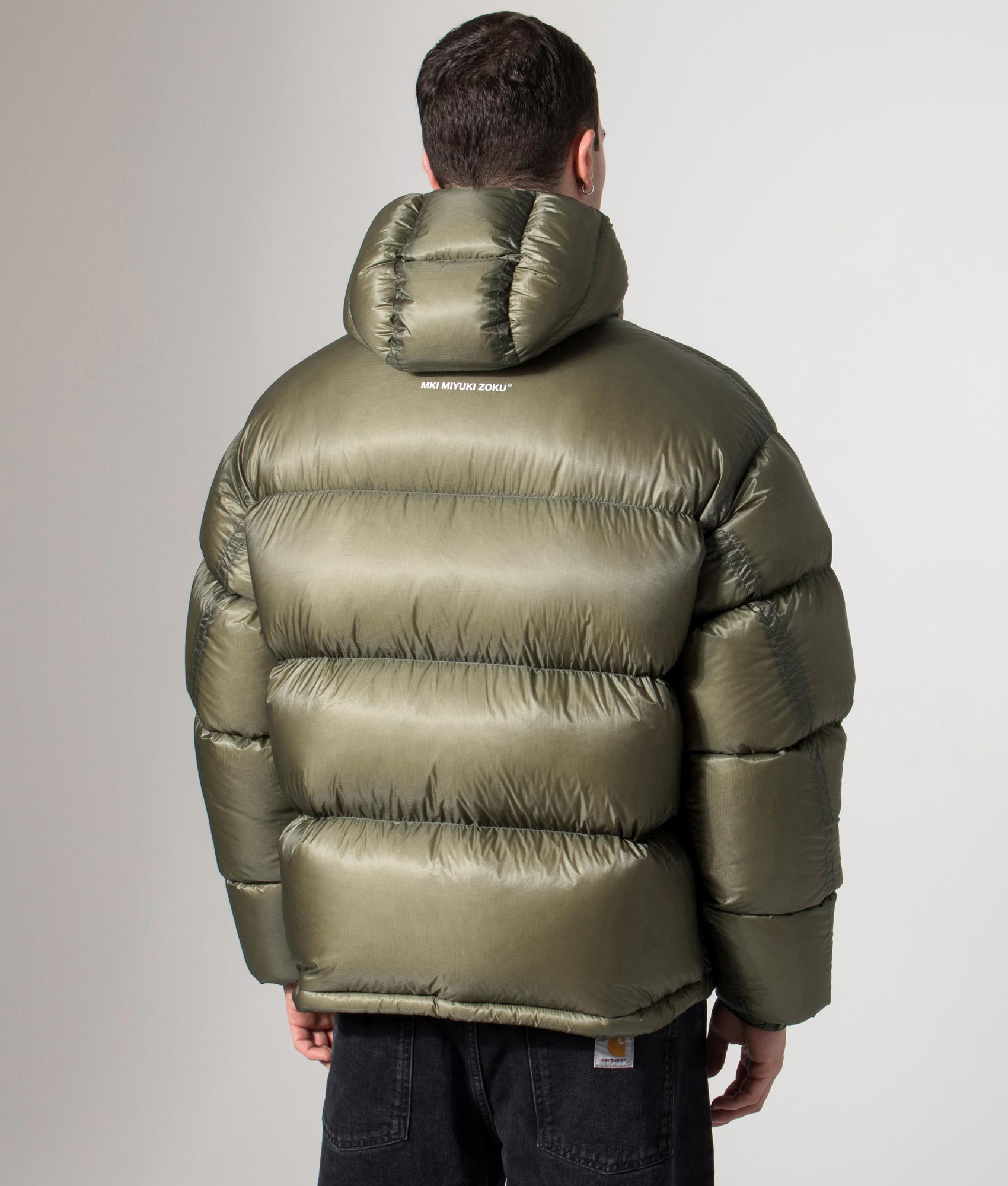 MKI MIYUKI ZOKU Translucent Bubble Jacket in Olive at EQVVS Menswear. Back model shot.
