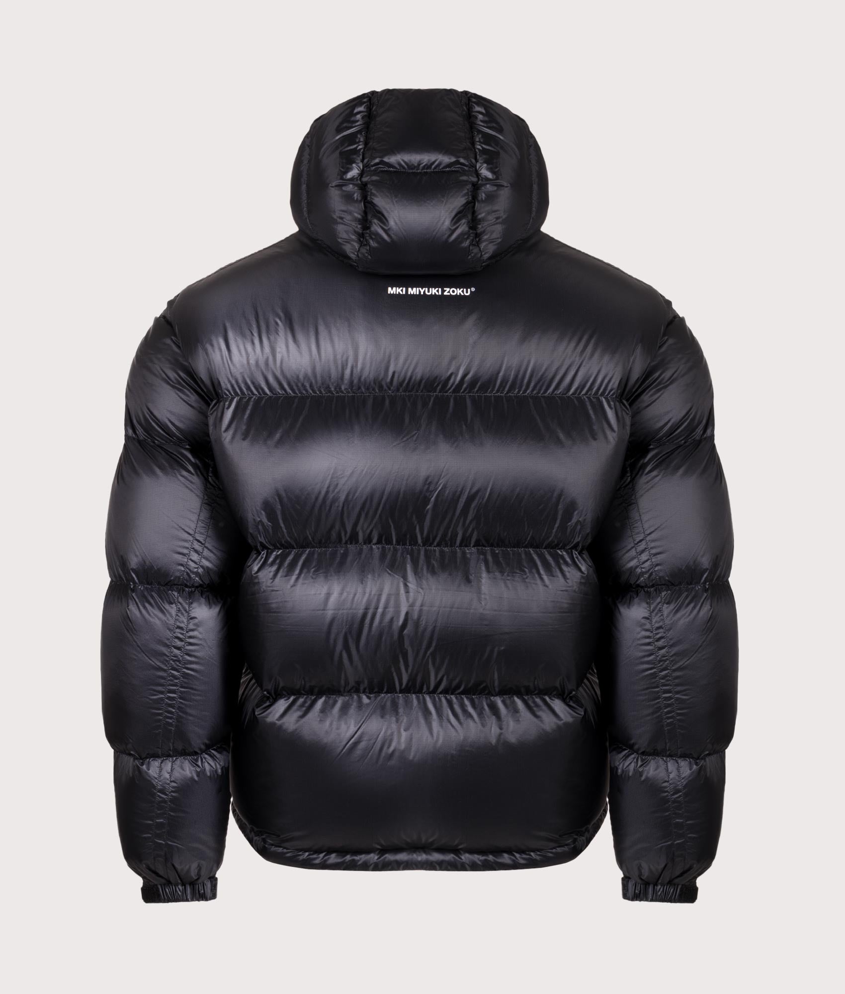 MKI MIYUKI ZOKU Translucent Hooded Bubble jacket in Black at EQVVS Menswear. Back shot.