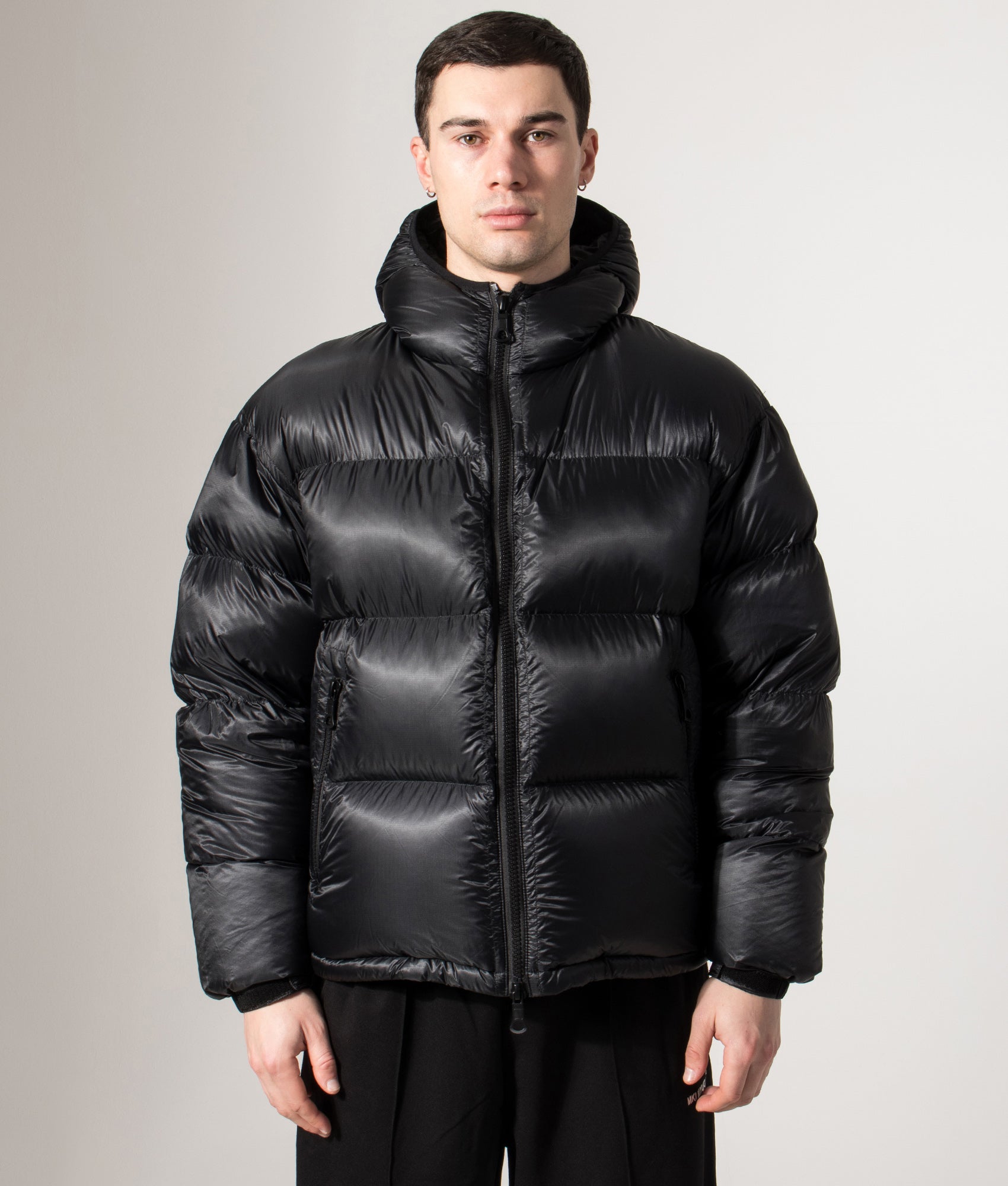 MKI MIYUKI ZOKU Translucent Hooded Bubble jacket in Black at EQVVS Menswear. Front model shot.