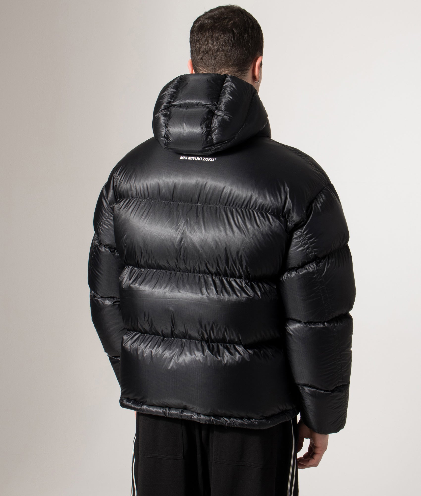 MKI MIYUKI ZOKU Translucent Hooded Bubble jacket in Black at EQVVS Menswear. Front back shot.