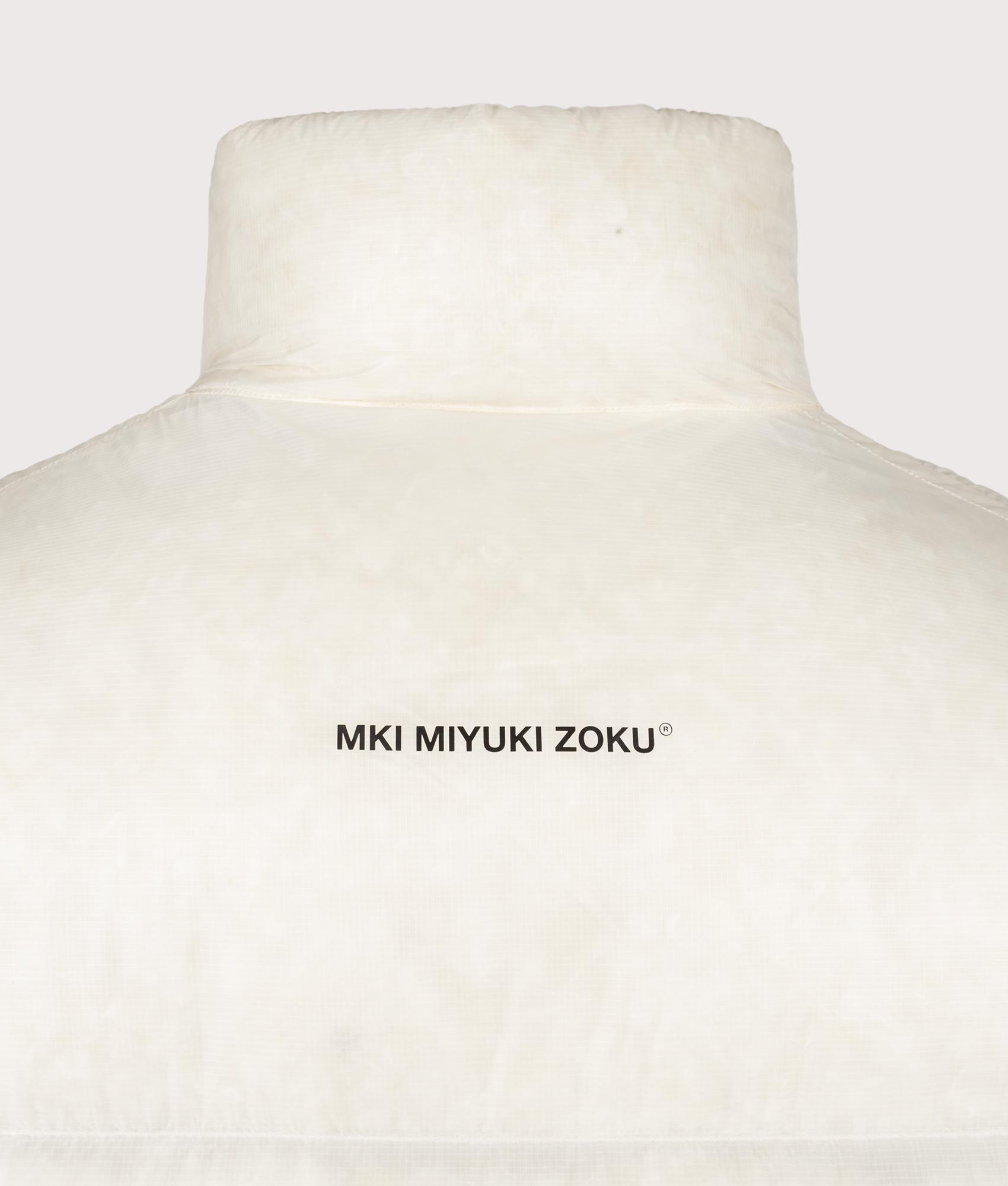 MKI MIYUKI ZOKU Translucent Funnel Neck Bubble Jacket in Off White at EQVVS Menswear. Back shot.