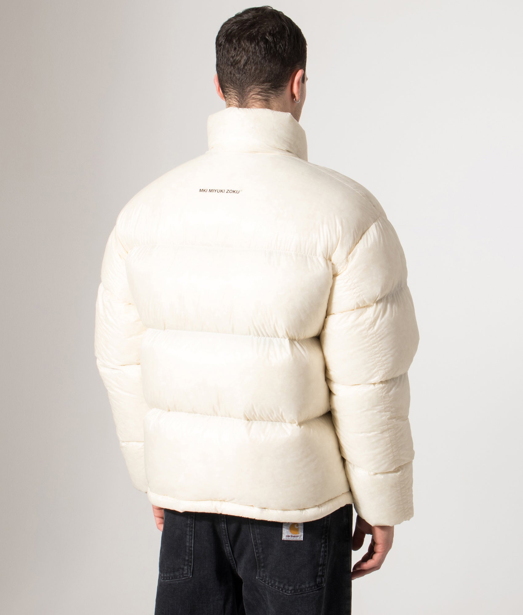 MKI MIYUKI ZOKU Translucent Funnel Neck Bubble Jacket in Off White at EQVVS Menswear. Back model shot.