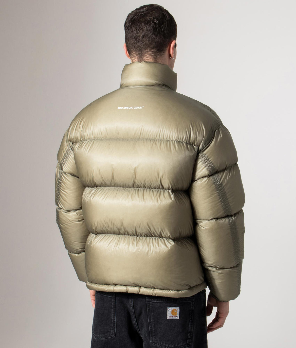 MKI MIYUKI ZOKU Translucent Funnel Neck Bubble Jacket in sage at EQVVS Menswear. Back model shot.
