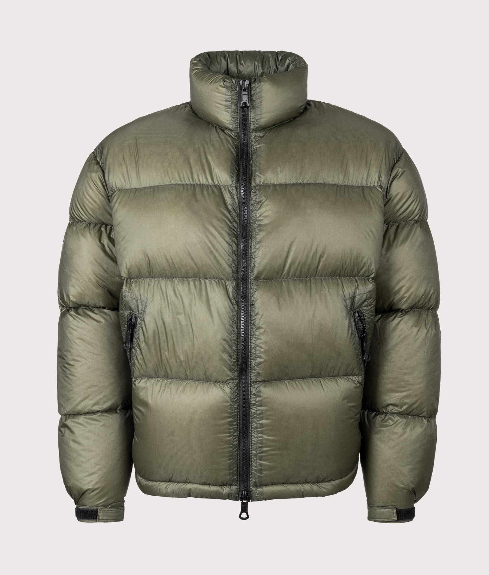 MKI MIYUKI ZOKU Translucent Funnel Neck Bubble Jacket in Olive at EQVVS Menswear. Front shot.