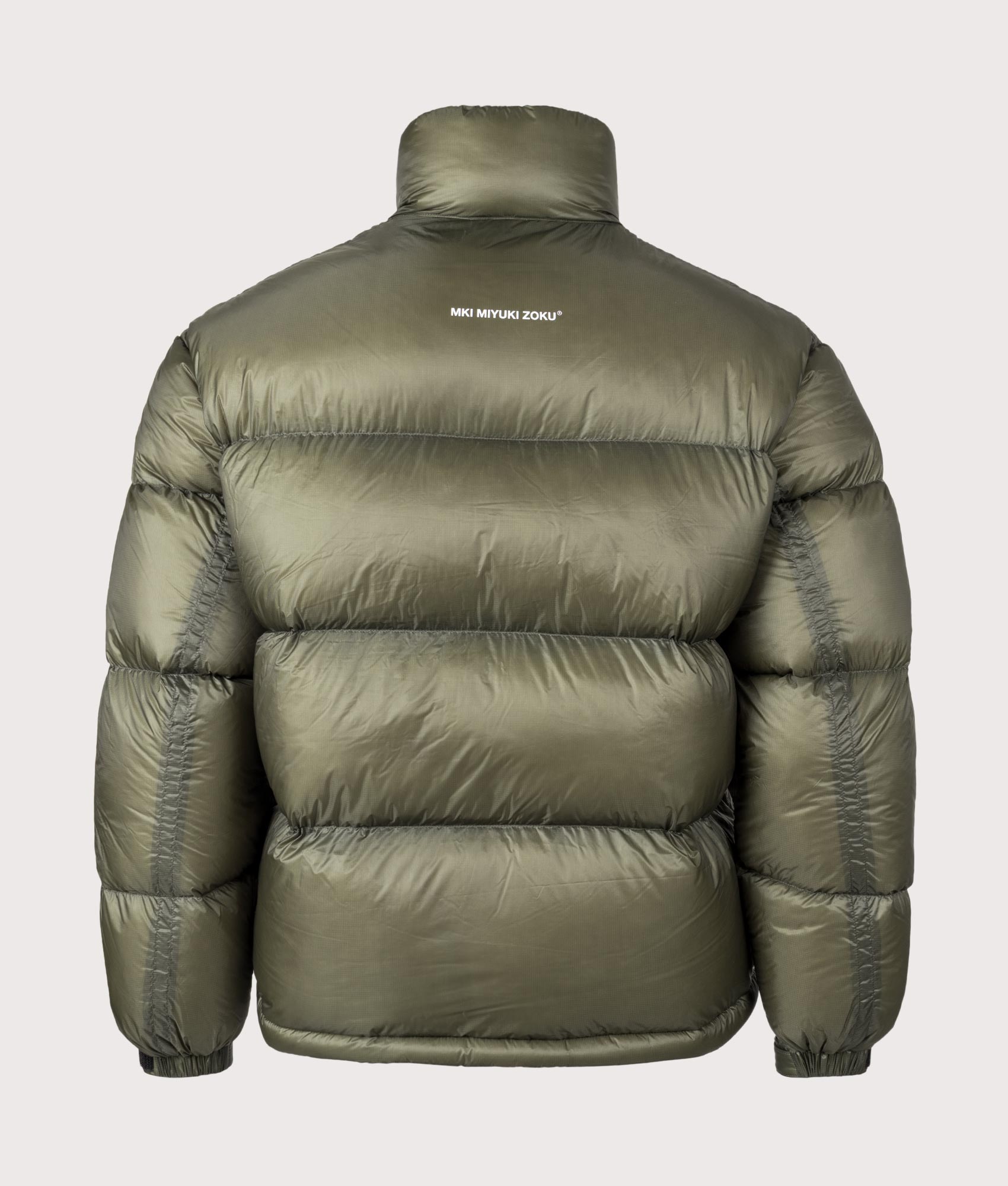 MKI MIYUKI ZOKU Translucent Funnel Neck Bubble Jacket in Olive at EQVVS Menswear. Back shot.