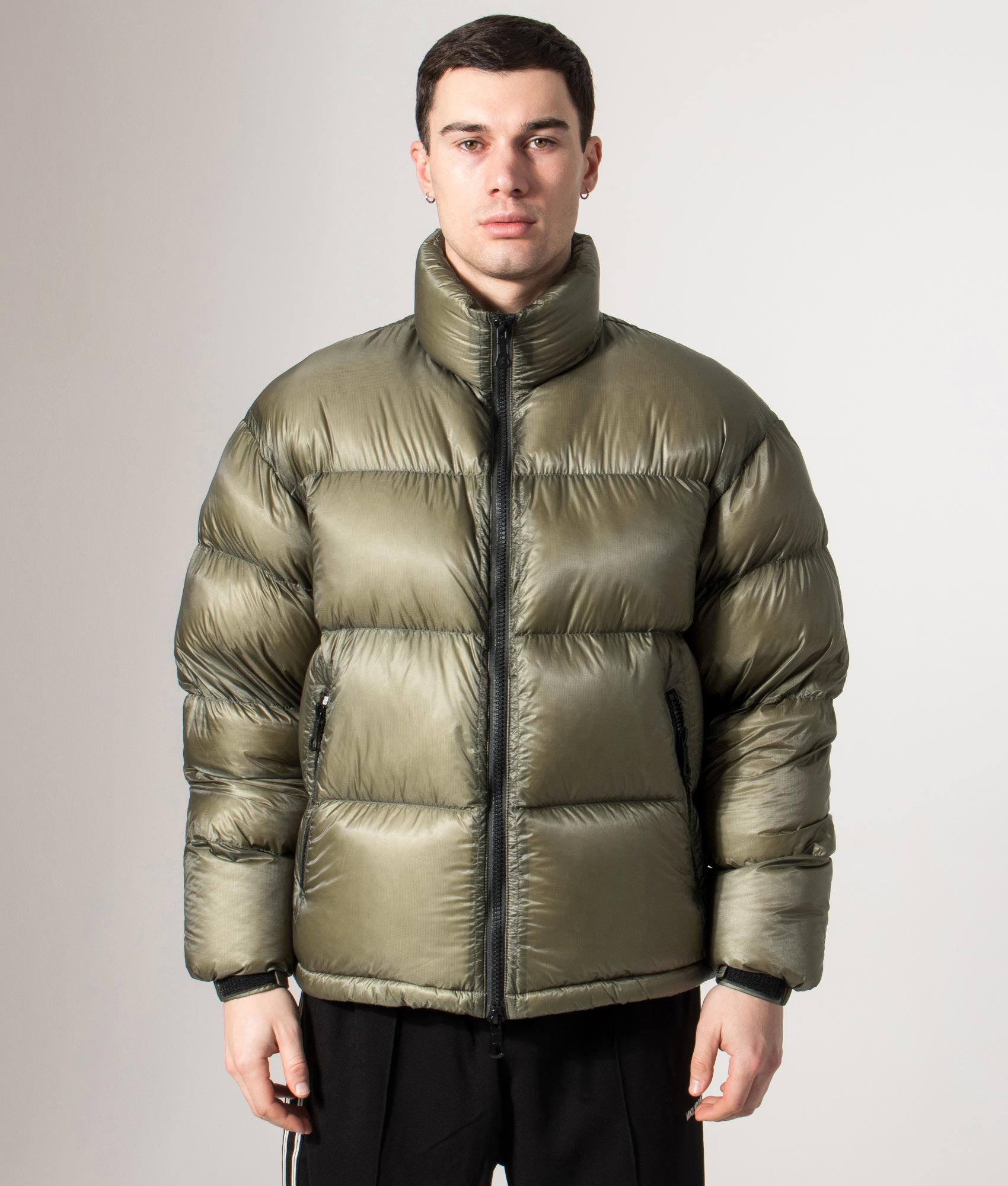 MKI MIYUKI ZOKU Translucent Funnel Neck Bubble Jacket in Olive at EQVVS Menswear. Front model shot.