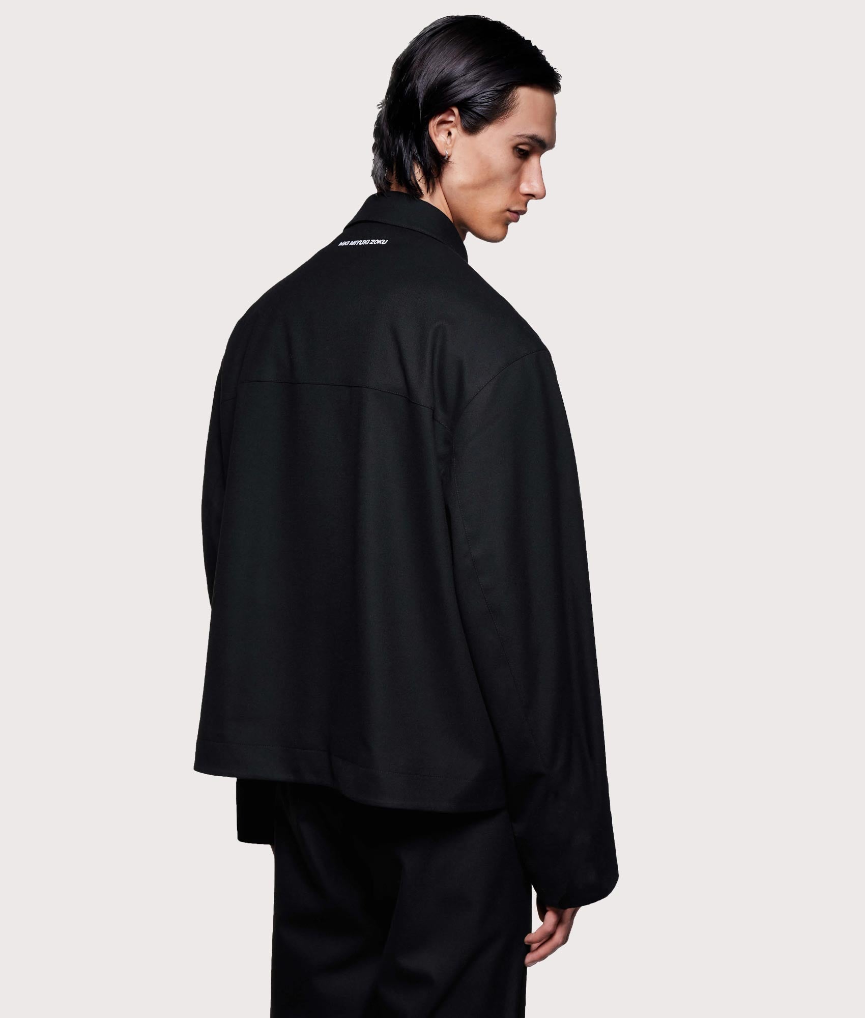 MKI MIYUKI ZOKU Suiting Rider Jacket in Black at EQVVS Menswear. Angled model back shot.