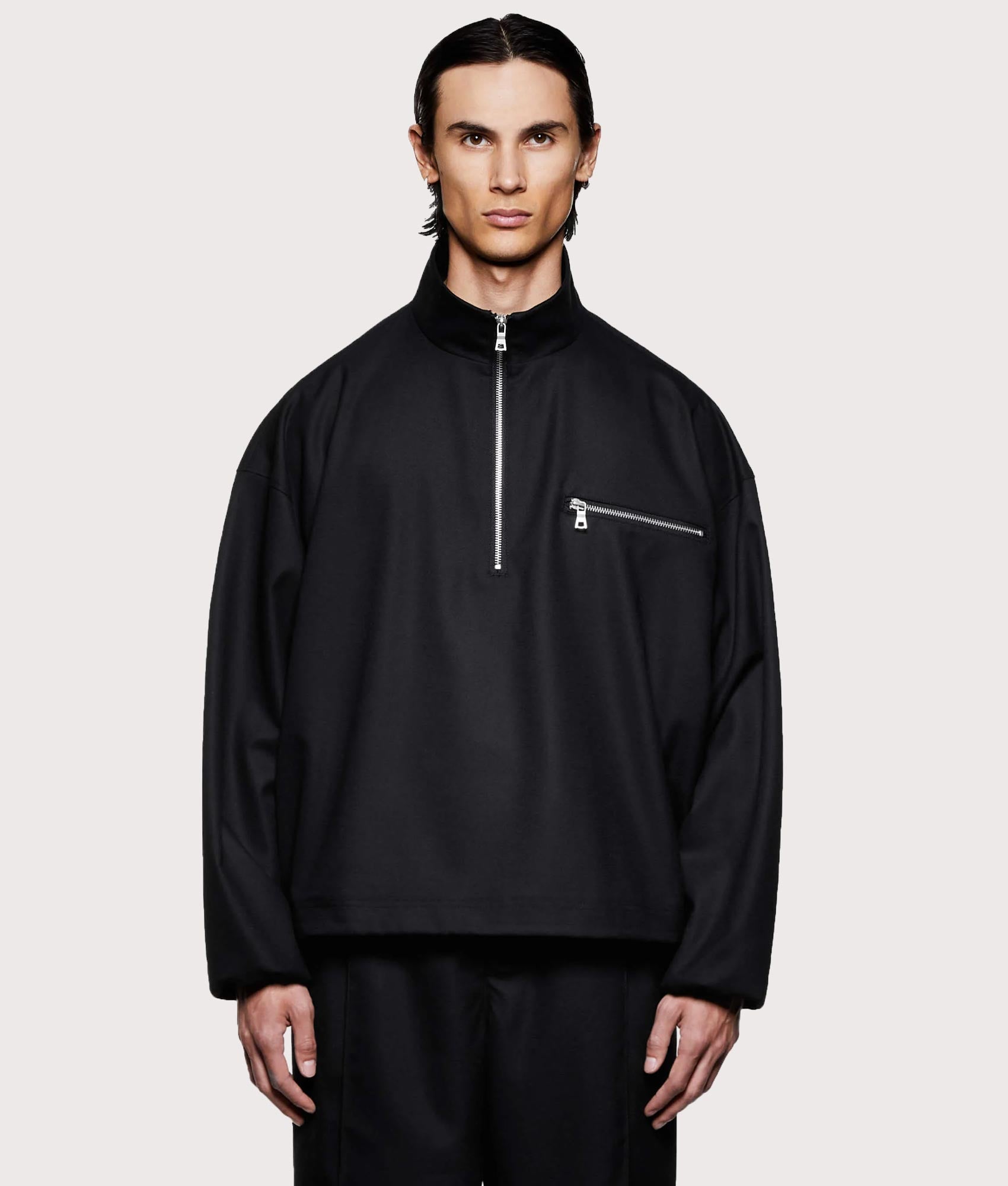 MKI MIYUKI ZOKU Suiting Quarter zip Sweatshirt in Black at EQVVS Menswear. Model front shot.