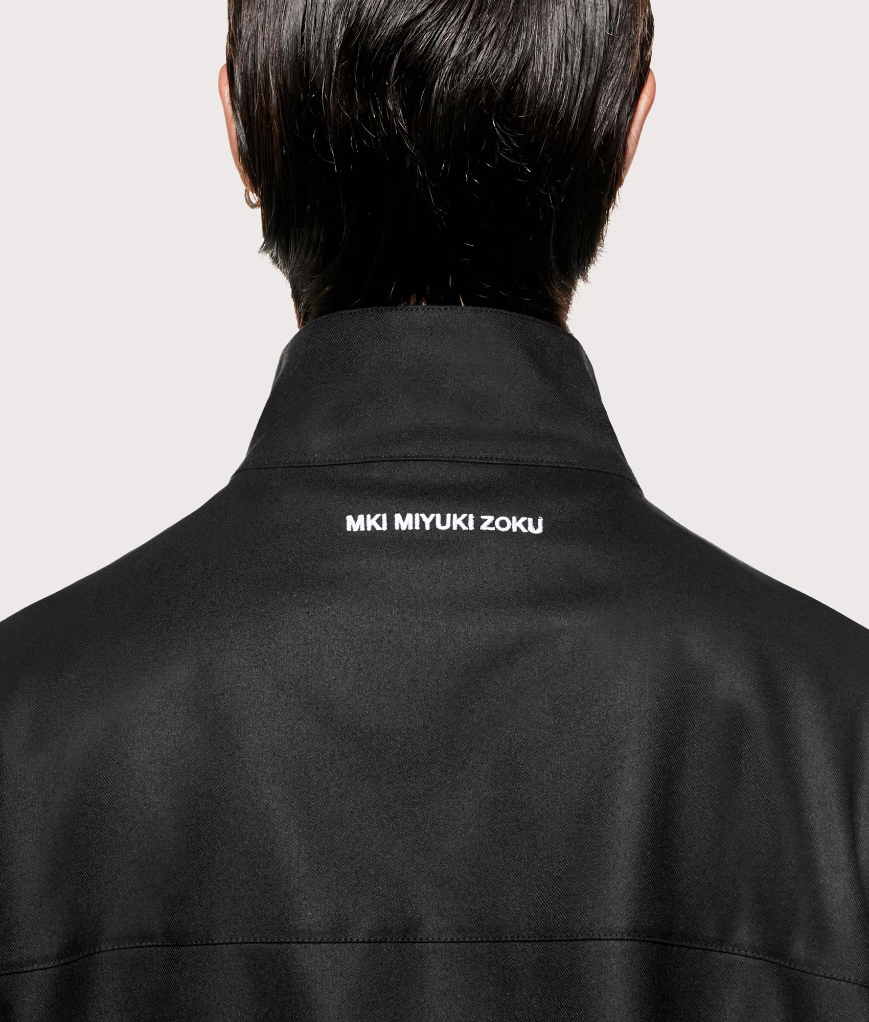 MKI MIYUKI ZOKU Suiting Quarter zip Sweatshirt in Black at EQVVS Menswear. Back detail shot.