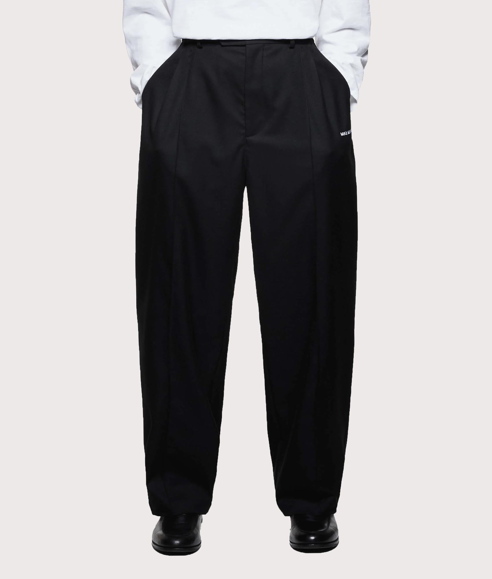 MKI MIYUKI ZOKU V2 Wide Leg Suit Pants in black at EQVVS Menswear. Model front shot.