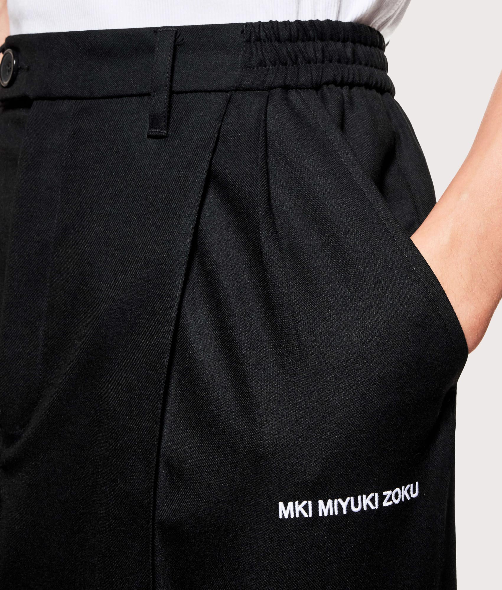MKI MIYUKI ZOKU V2 Wide Leg Suit Pants in black at EQVVS Menswear. Detail shot.