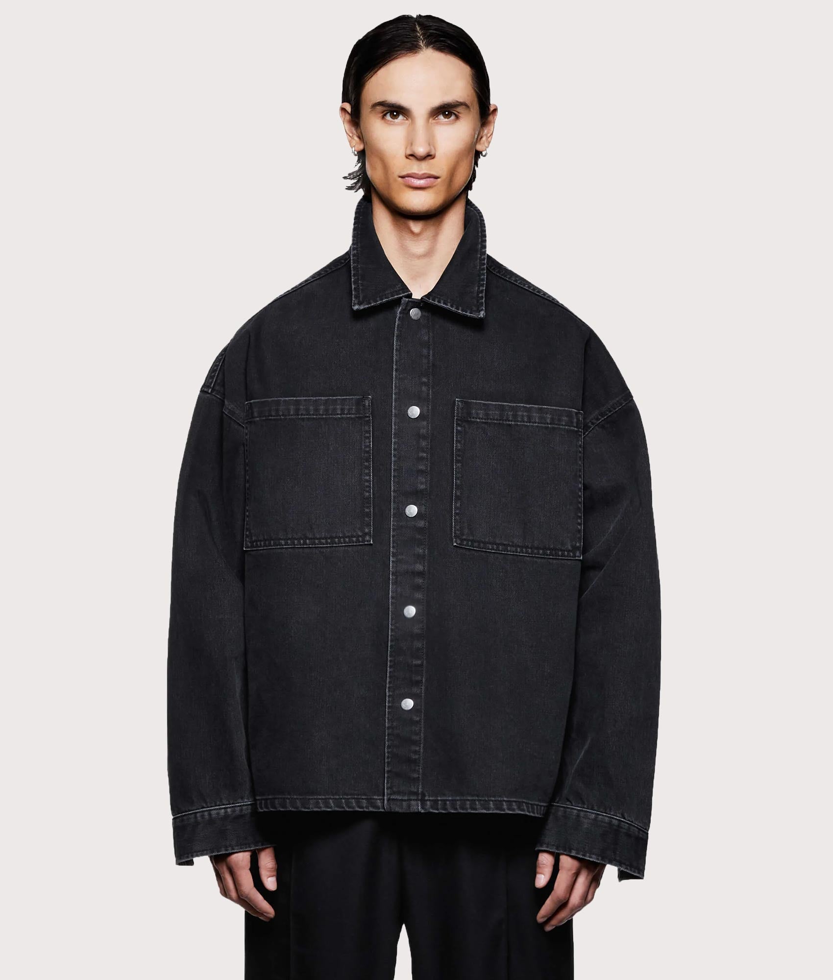 MKI MIYUKI ZOKU Denim Box Overshirt in Black Wash at EQVVS Menswear. Model front shot.