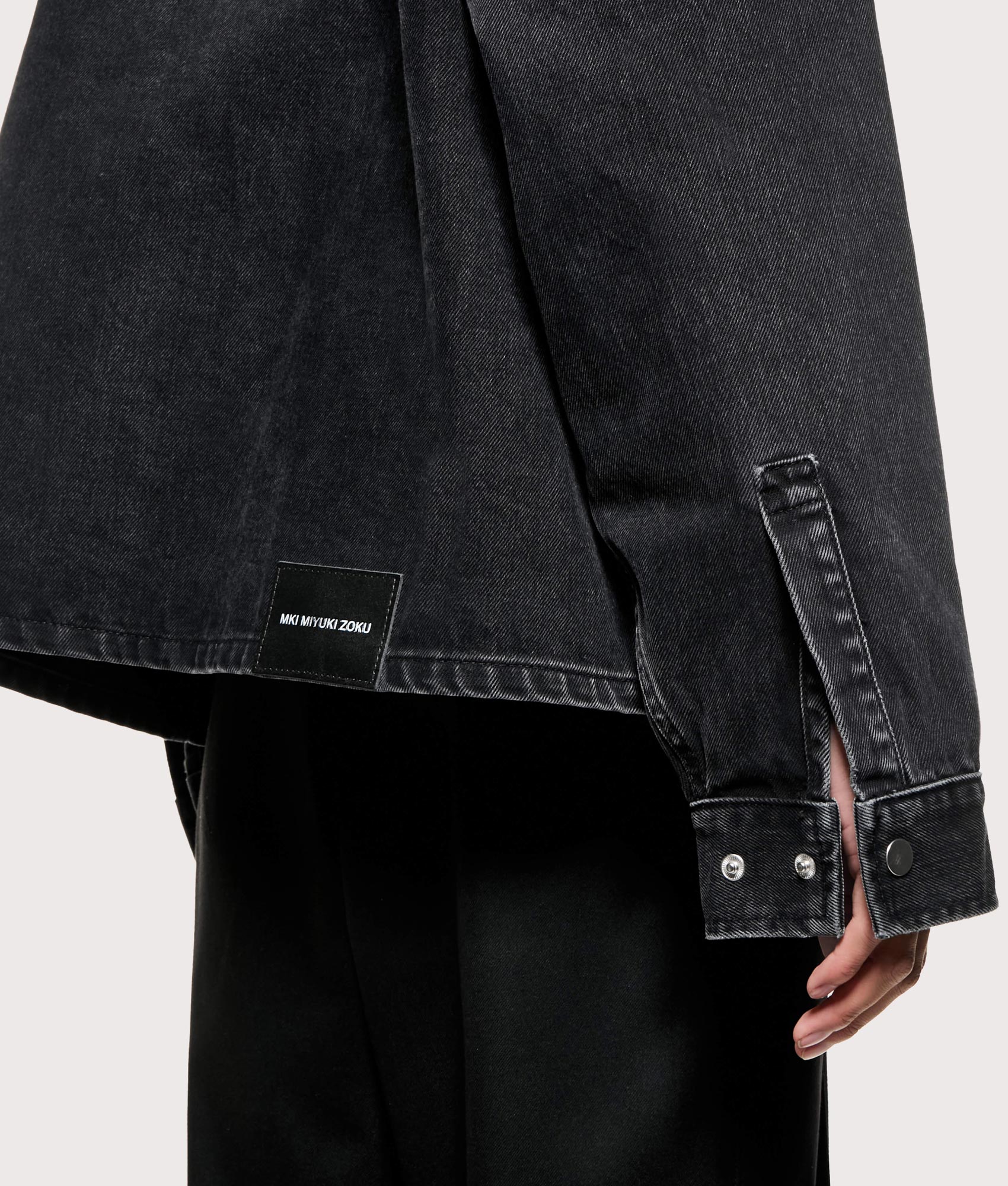 MKI MIYUKI ZOKU Denim Box Overshirt in Black Wash at EQVVS Menswear. Detail shot.