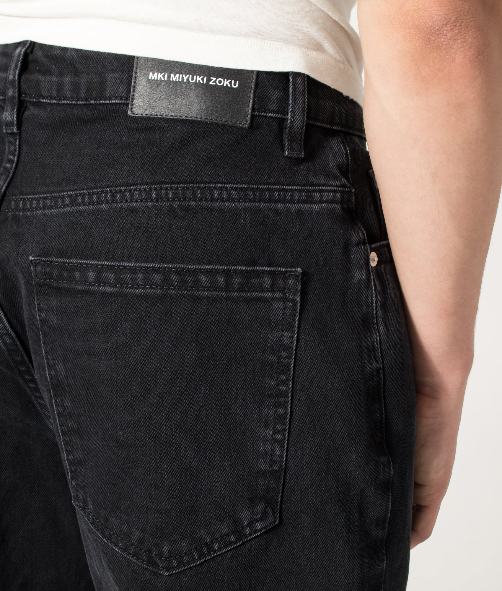 MKI MIYUKI ZOKU Denim Classic Jeans in Black Wash at EQVVS Menswear.  Back detail shot.