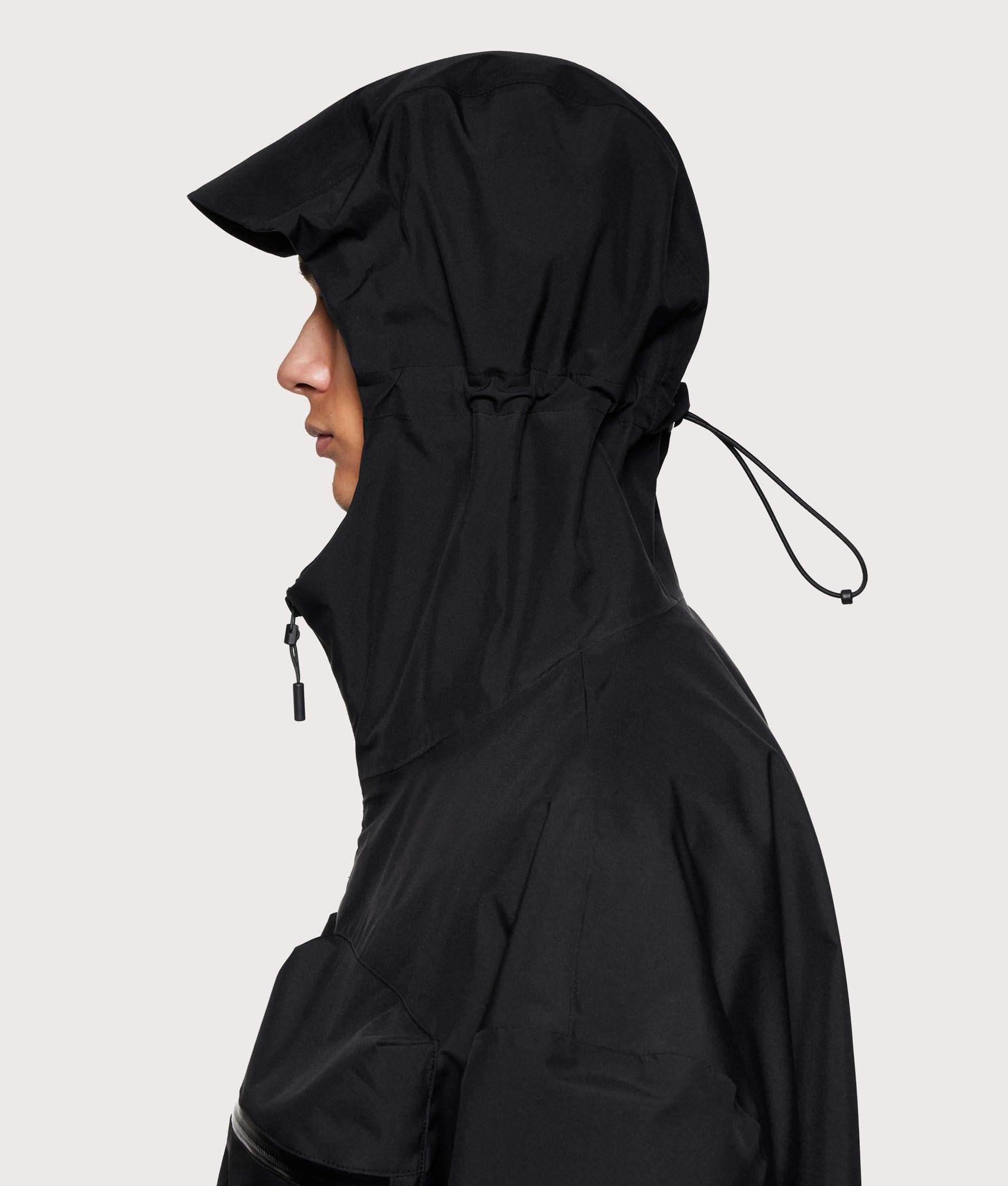 MKI MIYUKI ZOKU Shell Box Jacket in Black at EQVVS Menswear. Side hood shot.
