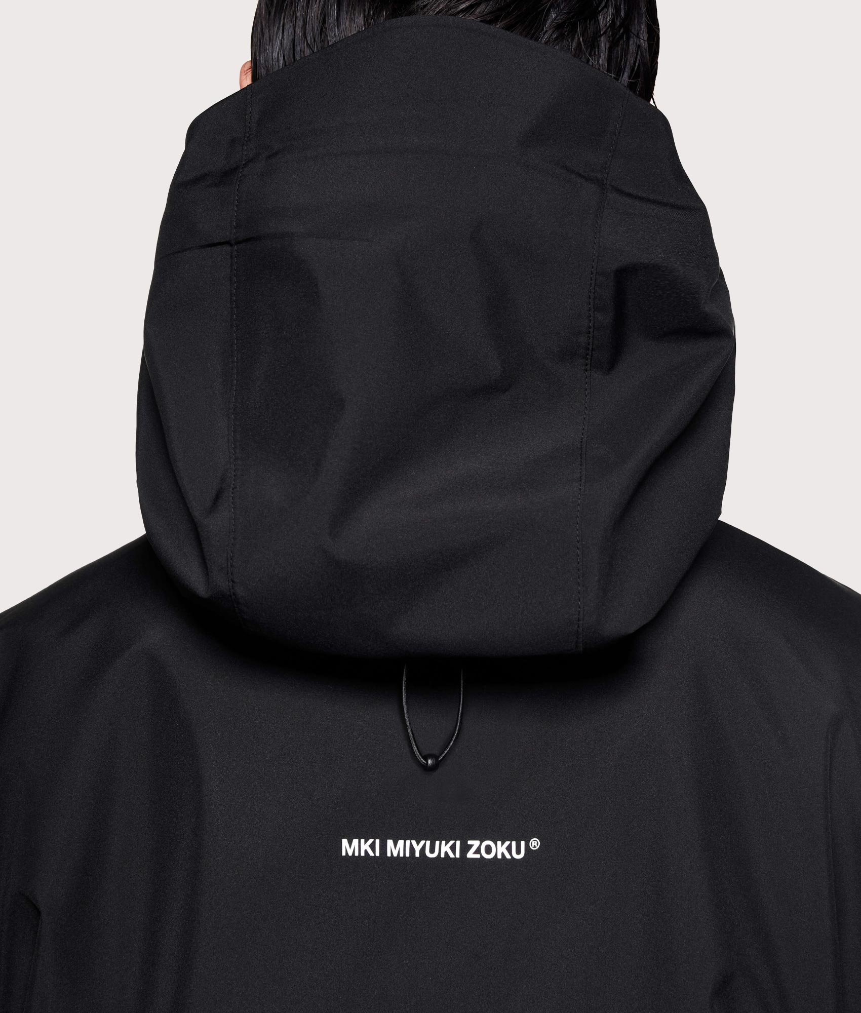 MKI MIYUKI ZOKU Shell Box Jacket in Black at EQVVS Menswear. Back detail shot.