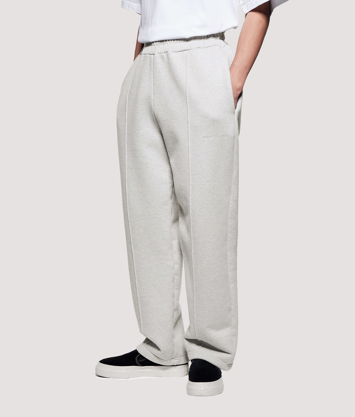 MKI MIYUKI ZOKU Relaxed Fit 800 GSM Superweight Wide Leg Joggers in Oatmeal at EQVVS Menswear. Angled model front shot.